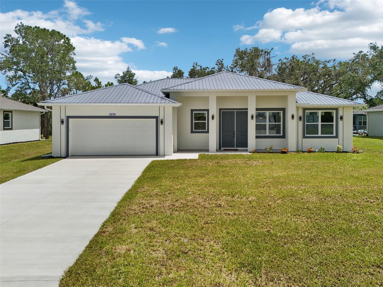 Brand new construction featuring a durable metal roof, full impact protection with windows, doors, and garage door, plus a stunning double 8-foot front entry door. Located in a desirable NO flood zone with no HOA restrictions, this home is Florida Green Building Certified, ensuring low monthly utility bills and reduced insurance costs. Inside, enjoy soaring 10-foot ceilings, LED lighting throughout, and ceramic tile flooring in every room for a modern and seamless look. The gourmet kitchen boasts solid wood cabinets with soft-closing features, granite countertops throughout the entire home, and a garbage disposal for convenience. Every detail has been designed with quality, including heavy-duty modern door hardware for a sleek finish. Built to the highest standards, this home offers long-term savings, storm-ready peace of mind, and luxury finishes all in one move-in-ready package.