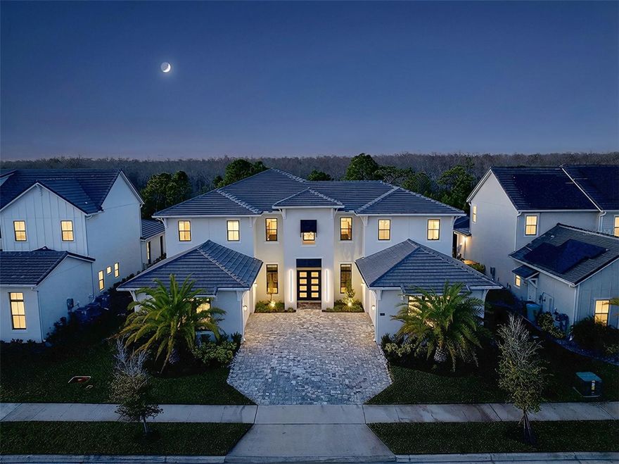 One or more photo(s) has been virtually staged. Luxury, privacy, and an exceptional lifestyle converge in this extraordinary estate located within Laurel Point, Lake Nona’s exclusive 24-hour gated enclave of just 124 custom homes. Ideally positioned in the heart of Lake Nona, this home offers effortless access to Medical City, Boxi Park, Orlando International Airport, USTA, KPMG, premier shopping and dining, and is within two miles of SR-417 and SR-528, providing seamless travel throughout Central Florida. Built by Toll Brothers, this impressive VAREN Model sits on a lush, oversized conservation lot and showcases over $1,000,000 in thoughtfully curated upgrades, delivering a truly custom living experience. Constructed primarily of solid block on both levels and enhanced with additional insulation throughout (including both garages), the home features double-paned insulated windows, solid core interior doors, EV charging, dual 200-amp garage services with a 400-amp disconnect, and infrastructure designed for longevity, comfort, and efficiency. Spanning nearly 6,700 square feet, the open and light-filled floor plan offers five en-suite bedrooms, including the primary and a secondary suite on the main level, with three additional suites upstairs. Soaring 30-foot ceilings, dramatic dual wood staircases with modern custom railings, and premium finishes throughout create a striking first impression from the moment you enter through the covered entry and double front doors. The chef’s gourmet kitchen is a masterpiece, featuring professional-grade stainless steel appliances, extended custom cabinetry, a massive island with seating, glass inlays, accent lighting, built-in coffee and cappuccino machine, under-counter wine refrigerator, and a spacious walk-in pantry. Designer lighting, tray ceilings with crown molding, custom wall treatments, premium flooring, and floor-to-ceiling tile in every bathroom elevate the home’s refined aesthetic. Designed for both productivity and entertainment, the residence includes dual executive offices (one on each level), a spacious upstairs loft, and a massive media and movie room. Storage is abundant, complemented by two oversized double-car garages, each with insulated doors and private home entry. One garage features a custom mudroom adjacent to the large walk-in laundry room with utility sink, upgraded cabinetry, AV hub, and natural light.
The outdoor living experience is nothing short of spectacular. A $275,000 resort-style pool and spa with elevated retaining wall, spraying deck jets, bubbling sun shelf, and panoramic two-story screened enclosure overlooks a tranquil conservation backdrop. The covered lanai includes a full outdoor bath with shower, an incredible summer kitchen, and ample space for dining, entertaining, and relaxing in complete privacy.
Smart-ready and tech-forward, the home offers app-controlled pool systems, lighting, locks, enhanced WiFi with Cat-6 hard-wired connections, and built-in surround sound throughout the great room, kitchen, primary suite, and outdoor living areas. This is a rare opportunity to own a truly exceptional Lake Nona estate—one that seamlessly blends sophistication, comfort, privacy, and premier location to accommodate the most discerning buyer. Schedule your private showing and experience this remarkable home firsthand.