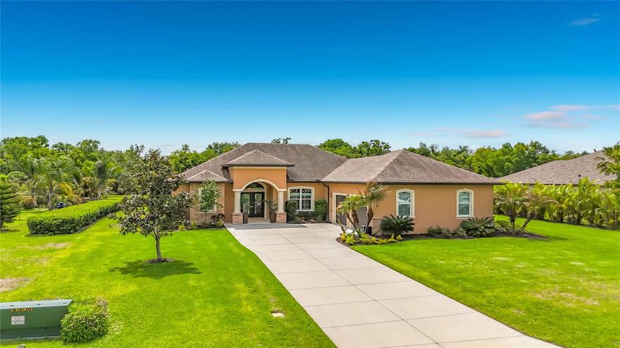 Welcome to this beautiful, over-the-top custom home situated on just over a half-acre of meticulously maintained property. This exceptional 3-bedroom, 3-bath residence offers luxury, privacy, and thoughtful design at every turn. Step through the custom double front doors into an expansive great room featuring elegant tray ceilings and an open-concept layout that seamlessly connects the living area, gourmet kitchen, breakfast nook, and formal dining room—perfect for both everyday living and entertaining. Designed with both style and peace of mind, all windows and doors are hurricane-rated. The gourmet kitchen serves as the heart of the home, showcasing premium appliances, custom cabinetry, and abundant granite counter space. A second refrigerator in the laundry room adds extra convenience, along with upgraded shelving throughout the laundry, pantry, and office spaces. The home also features a whole-house water filtration system with reverse osmosis in the kitchen. The luxurious primary suite offers a spa-like retreat with a large soaking tub, walk-in shower, and heated towel bars, while all bathrooms include walk-in showers and upscale finishes. Each bedroom is enhanced with custom closets by design, and upgraded soundproofing in the walls ensures added privacy. Beautiful upgraded tile flooring flows throughout the home. Enjoy true indoor-outdoor living with triple sliding glass doors that open the great room to the lanai, creating an expansive entertaining space. The outdoor area is equally impressive, featuring a fully equipped outdoor kitchen with custom cover, a propane firepit with stone and granite accents, and a heated pool and spa enclosed with a no-see-um screen. The backyard is enhanced with professional landscape lighting for a stunning evening ambiance. Car enthusiasts and hobbyists will appreciate the air-conditioned and heated 3+ car garage with attic storage, as well as a separate, climate-controlled 676 sq. ft. workshop/RV garage—perfect for additional vehicles, storage, or projects. With two attic storage spaces and countless high-end upgrades throughout, this is truly a one-of-a-kind custom property offering luxury living at its finest.