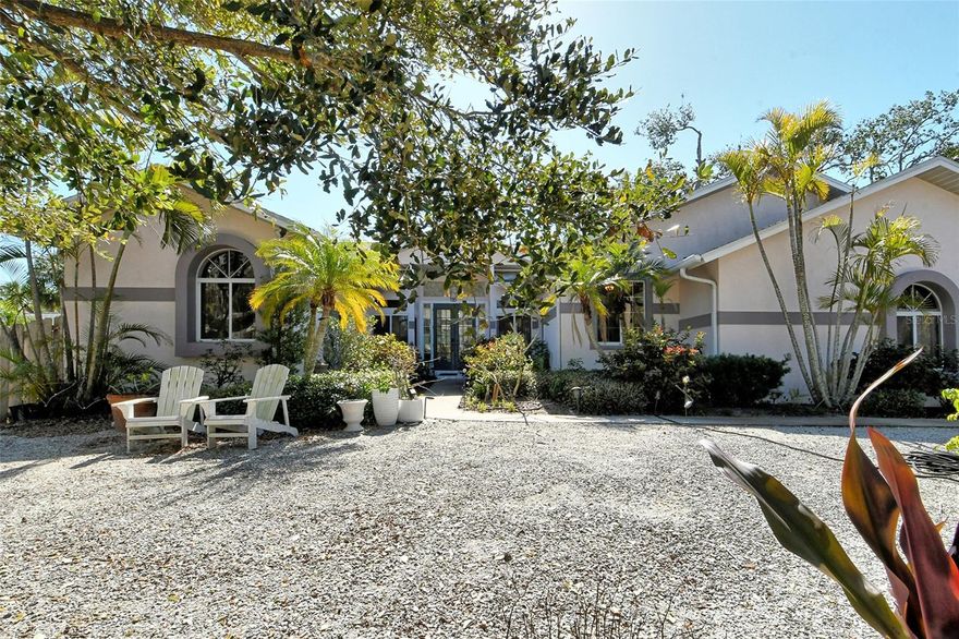 Nestled in the heart of Siesta Key, this home offers the perfect blend of relaxation and opportunity. Whether you're seeking a serene beach getaway, a lucrative vacation rental, or a full-time residence, this property checks all the boxes.  The home’s unique floor plan is flooded with natural light, creating a bright, inviting atmosphere throughout. A rare find, both the home and the garage are elevated, ensuring that all living spaces are conveniently located on a single level. This thoughtful design and high elevation provide easy access to the pool and give peace of mind – no flooding in the house or garage from recent storms.  Even the driveway is elevated, keeping your cars high and dry.  As you step inside, soaring 12-foot ceilings greet you in the foyer and main living area, with expansive glass sliding doors framing the view of the pool. The floor plan includes 3 spacious bedrooms, plus a versatile mother-in-law suite. The primary bedroom boasts enough room for a separate sitting area and direct access to the pool, while the second bedroom also enjoys direct pool views and access.  The dining room and fourth bedroom have been reconfigured to form a cozy mother-in-law suite, but the original layout could be easily reinstated.  Outdoor living takes center stage in this tropical oasis, with a heated pool offering the perfect retreat. The oversized, 26-foot deep two-car garage provides ample space for your toys and beach gear.  Recent updates include a tankless hot water system and a new pool heater installed in 2022.  Whether you choose to update the home to suit your personal style or enjoy its current coastal cottage charm, the possibilities are endless. Located in a tranquil, natural setting, this property can become your peaceful beach escape, a profitable rental investment or a combination of both.  Currently being used for short term rentals, and rental history available on request.  Just a short walk or bike ride to the renowned Siesta Key beaches, along with easy access to local dining, shopping, and nightlife.  This is a rare opportunity you won’t want to miss!