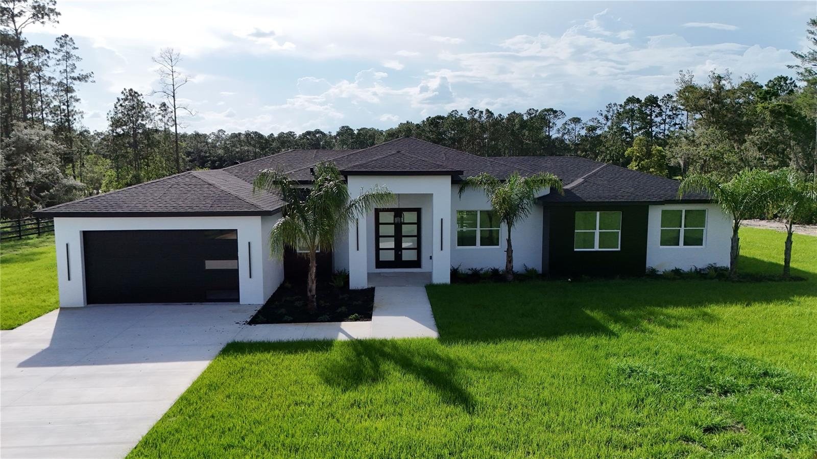 Under Construction. New Construction on 2.2 acres lakefront. Luxury home with 14' ceilings. No HOA. Price is for fully completed home with landscaping and after passing all Building inspections and your punch list inspection. Master Bath includes separate tub and a walk in shower with his and hers rainfall shower heads with separate controls. Claim your rural paradise. Zoned agricultural. Bring your horses and 4 wheelers. Plenty of room for barn, stables, chicken coop and storage buildings. Ride or walk off of your property to Seminole State Forest trails. Home is high and dry with no flood insurance required. 14 minutes to Publix. 16 minutes to SR429/Wekiva Parkway Sorrento. 10 minutes to St Johns River Boat ramp at at Ed Stone Park.