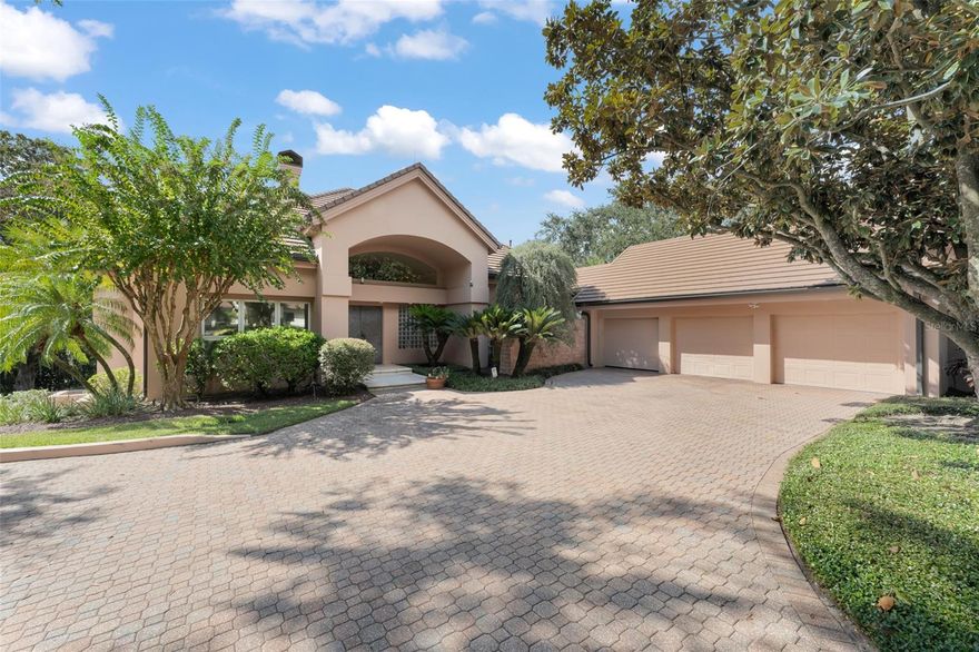 Within the gates of the renowned Isleworth Golf & Country Club, this beautiful lakefront estate captures the essence of timeless luxury and gracious living. Poised on the shores of Lake Bessie, the 5,548 square-foot residence unfolds across two levels, designed to frame sweeping water views and create effortless spaces for both grand entertaining and quiet retreat. The upper level greets guests with custom French entry doors that flow into the open formal living and dining rooms, perfectly designed for gatherings. The kitchen is spacious and inviting, offering casual dining and seamless access to the main living areas. A richly appointed library adds warmth and refinement, while two en-suite bedrooms complete this floor, including the primary suite. With its oversized windows capturing endless lake vistas, a large sitting area, exterior balcony, and an en-suite bath featuring dual vanities, a soaking tub, and walk-in shower, the primary suite is a sanctuary of light and serenity. On the lower level, the estate offers two expansive bonus areas joined by a well-equipped kitchenette. Ideal for gaming, entertaining, or working from home, both spaces connect effortlessly to the sun-drenched pool terrace—seamlessly integrating indoor luxury and outdoor living. A stunning mature oak tree anchors the property's beautiful lakefront grounds, stretching gracefully toward the water’s edge—a signature of the property’s natural beauty. Beyond the oak tree, Lake Bessie shimmers in full view, offering a breathtaking backdrop to the estate. A rare combination of elegance, versatility, and iconic setting, this residence presents a lifestyle within one of Central Florida's finest communities.