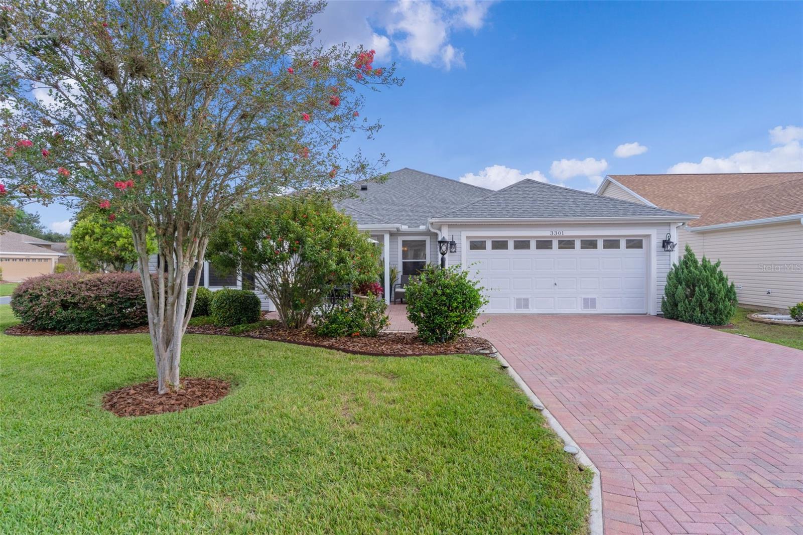 ~NO BOND~ ~Roof 2020~ ~HVAC 2017~ ~HOT WATER HEATER 2015~ Beautiful 3/2 HIBISCUS (SIMILAR TO GARDENIA MODEL) model on a CORNER LOT in GLENBROOK, featuring a BRICK PAVER driveway. Step inside to soaring VAULTED CEILINGS and elegant PORCELAIN tile in the entry, living, and dining rooms. The living area offers window cornices, upgraded blinds and an upgraded ceiling fan, while the dining room shows UPDATED lighting beneath HIGH ceilings. There is crown molding in the primary living areas. The kitchen is designed for function and style with CERAMIC tile flooring, GRANITE countertops, STAINLESS STEEL appliances including an INDUCTION STOVE, recessed lighting, upgraded blinds, an EAT-IN nook, and a GAS HOOK-UP OPTION. The spacious primary suite features BAMBOO flooring, VAULTED ceilings, 2 WALK-IN closets, and new blinds and curtains. The ensuite bath includes a TERRASTONE WALK-IN SHOWER, GRANITE counters, vanity, updated mirrors, linen closet, CERAMIC tile, and a ceiling fan. There are 2 guest bedrooms, one with BAMBOO flooring, ceiling fan and built-in closet and the other with ceramic tile flooring, ceiling fan and upgraded blinds. The guest bath includes CERAMIC tile, tub surround, linen closet, and GRANITE counters. An additional feature is the INSIDE LAUNDRY ROOM with CERAMIC tile, cabinets, shelving, and Samsung appliances. Relax year-round in the GLASS-ENCLOSED LANAI with textured tile flooring, telescoping sliders, and 2 ceiling fans. The 2-garage is equipped with built-in cabinets, attic stairs, and ceiling fan. A stunning blend of updates, space, and style—this Glenbrook gem is move-in ready! Quick golf cart ride to the Glenview Country Club and numerous Executive Golf courses, and Recreation Centers. Easy access to Southern Trace Shopping Center, Lake Sumter Landing, and Spanish Springs Town Square for plenty of shopping, dining and medical needs.