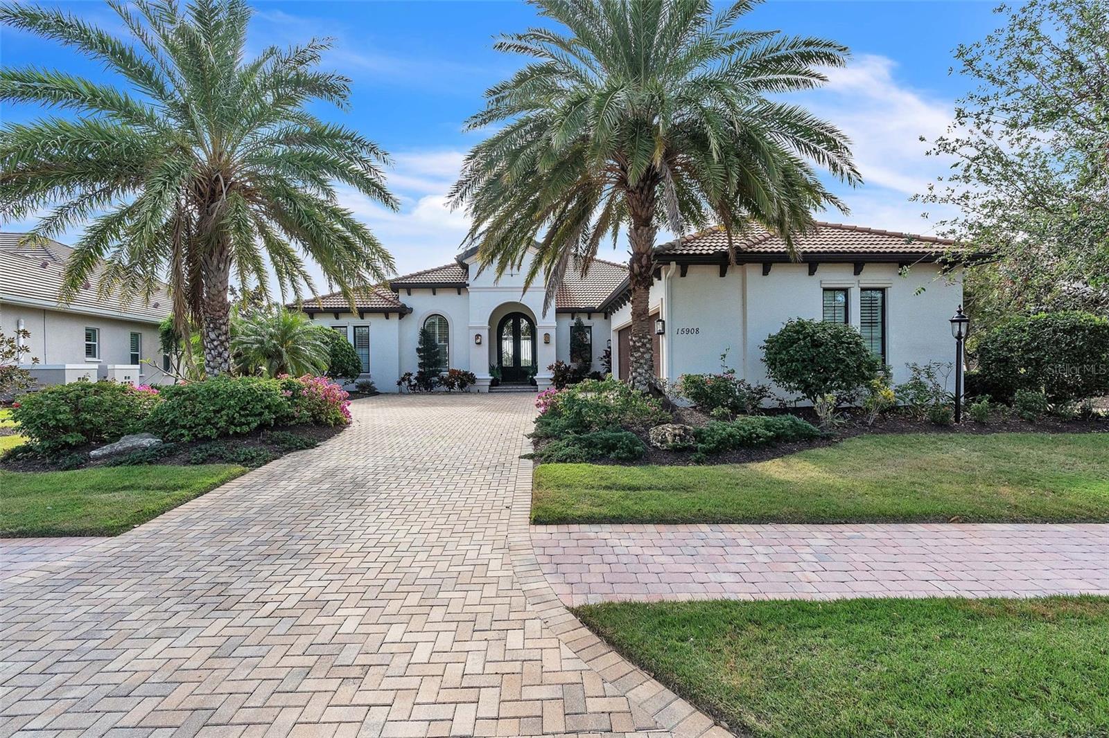 PRICE REDUCE. Discover this stunning custom home featuring 3 bedrooms,3 and half bathrooms,a bonus room, and an office.Built by John Cannon .Located in the beautiful enclave of a gated community of Country Club East.This elegant residence boasts magnificent arched double iron-glass front doors that define the entry.The Open living space showcases 12-foot beamed ceilings and gas fireplace. A gourmet chef’s kitchen is equipped with custom cabinets, granite counter tops,top-of-the-line “Viking” appliances and walk-in pantry. A massive island provides ample space for entertainment. The large bonus room offers flexible space for media and entertainment,while the spacious office adds functionality.The master bedroom suite features a generous layout, sitting area, and dual walk-in closets.
The Luxurious master bathroom includes a double sink vanity, free-standing modern bathtub, and a spacious walk-in shower with frameless glass enclosure. Custom plantation shutters and custom window treatments adorn the entire house.An impressive outdoor view of the golf course and lake greets residents.The oversize screened lanai features a heated saltwater pool and spa.An outdoor kitchen boasts a stainless steel grill , sink, and extractor fan,all overlooking a tropical oasis. Additional features include a spacious laundry room with ample cabinet space. Over sized three-car garage. Residents of this exceptional estate also enjoy access to amenities including three pools, a fitness center, and a clubhouse. Optional membership to the Lakewood Ranch Country Club is available.The property is zoned for A-rated schools and is in close proximity to shopping, dining, and world-class beaches. Seize this opportunity to experience this upscale living.
