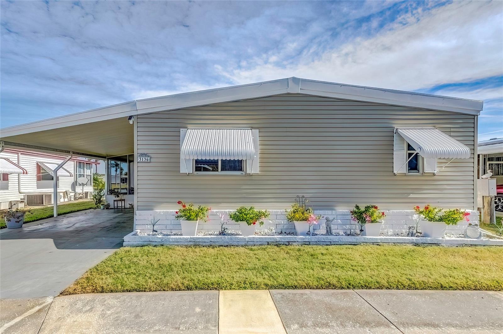 Completely remodeled and a must-see, this home in a 55+ community offers stunning lake views. The home has a new kitchen with a full suite of Frigidaire Gallery stainless steel appliances, including a range/oven, refrigerator, microwave, and dishwasher. Other features include new subflooring with laminate overlay, remodeled bathrooms, and a heated and air-conditioned Florida room. You'll also find a small office space overlooking the water, a screened lanai off the carport, a double storage shed, and a newer electrical panel. To top it all off, a new deck built over the water provides the perfect spot for relaxing.
Measurements are approx. Buyer to verify all information which is deemed accurate. Easy to show with appointment.