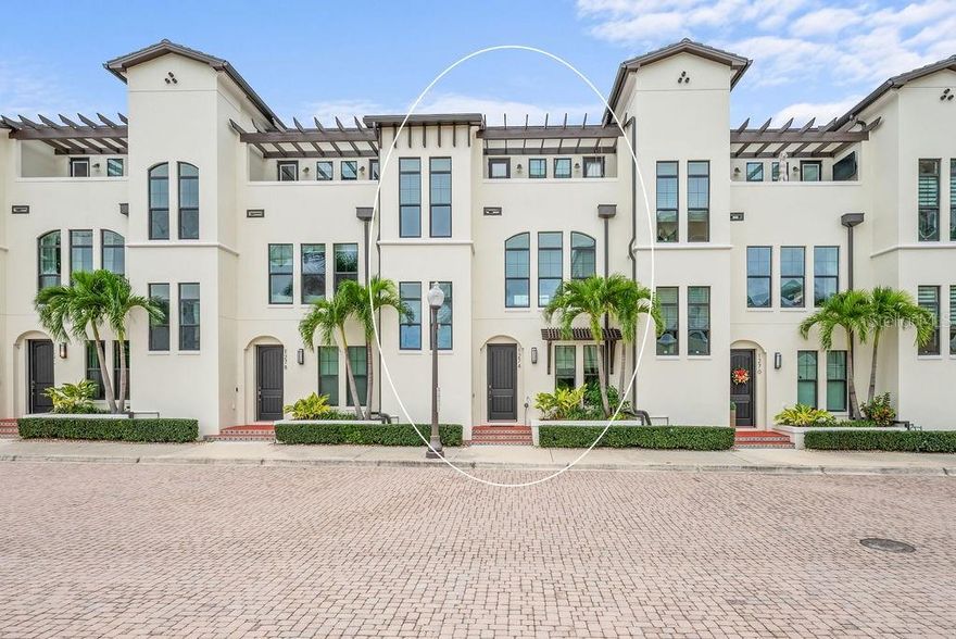 One or more photo(s) has been virtually staged. Perfectly positioned in the heart of downtown Sarasota, this refined three-story residence in the coveted enclave of Valencia Rosemary Place embodies the essence of modern luxury living. Tucked along a quiet private lane with tranquil park views, the home offers 2,291 square feet of impeccably curated interiors, including three private bedroom suites, 3.5 baths, and a luminous main living level designed for effortless everyday living and sophisticated entertaining. A charming terrace off the primary suite adds a serene outdoor escape.

Every detail has been elevated with thoughtful intention. Rich hardwood flooring, soaring ceilings, crown molding, premium plaster-finished walls, and designer lighting create a warm, contemporary elegance throughout. The reimagined chef’s kitchen serves as the home’s centerpiece—an artful blend of style and function—featuring quartz surfaces, solid wood cabinetry, Moroccan tile accents, open shelving, KitchenAid appliances, a gas range, and an inviting island with expanded pantry storage.
The primary suite offers a peaceful retreat with its own private terrace, while two additional guest suites provide exceptional comfort and privacy for family or visitors. A two-car garage, generous storage on every level, and low-maintenance living further enhance the home’s appeal for both full-time and seasonal residents.
All of this is just minutes from Sarasota’s celebrated dining, boutique shopping, performing arts venues, and The Bay waterfront—creating a rare opportunity to enjoy refined, lock-and-leave living in one of the city’s most vibrant and walkable neighborhoods.