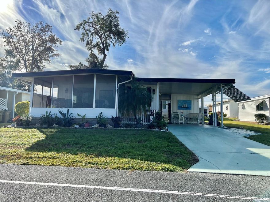 Tucked away on Palo Verde Drive, this enchanting 2-bedroom, 2-bath home offers 864 square feet of warmth, character, and effortless Florida living. A long driveway welcomes you home each day, complete with a covered golf cart pad for added ease. A sturdy metal roof crowns the home, while major updates, including electrical panels (2014–2017), HVAC (2018), and water heater (2014), bring peace of mind and dependable comfort. Galvanized and copper plumbing further reflect the solid construction and attentive care this home has received over the years. Step inside and feel the softness of beautifully maintained carpet underfoot, creating a space that feels both intimate and inviting. The kitchen and baths feature tile flooring for easy upkeep and lasting durability. The fully equipped kitchen is ready for everything from slow Sunday breakfasts to cheerful gatherings with friends. Both bathrooms showcase walk-in showers and refreshed vanity cabinets, blending function with a clean, updated feel. Elegant window treatments frame each room with warmth and personality, and the tasteful furnishings give the home a thoughtfully styled, move-in-ready appeal. At the front of the home, a bright and breezy screened Florida room captures sunlight and gentle crosswinds, an ideal setting for morning coffee or quiet afternoons. The screened back porch offers another peaceful haven, perfect for unwinding in the evening air or enjoying relaxed conversations year-round. A generously sized laundry room with an adjoining workshop provides space for creativity, projects, or extra storage, adding versatility to everyday living. This is more than a well-kept residence; it’s a home with a heart. Comfortable, inviting, and thoughtfully updated, it offers a place to settle in, slow down, and truly savor the feeling of home...........Hawthorne at Leesburg is an active, resident owned, 55+ cooperative, waterfront, gated community, with beautifully landscaped grounds, lakes with illuminated fountains and a relaxing and comfortable gazebo. The affordable monthly maintenance fee of $397 includes water, sewer, lawn mowing, private emergency services and storage space for recreational vehicles, boats, trailers and much more! The beautiful clubhouse is complete with a full-time program coordinator, more than 100 different activities and seating for 550. It has a hospitality lounge, card rooms, craft rooms, billiard room, fitness center, library, fine arts room and many more. There is excellent fishing, outdoor geo-thermally heated pool and two enclosed therapeutic pools. Hawthorne boasts a private marina monitored by an electronic security system with over 120 boat slips and access to the Harris Chain of Lakes and beyond.