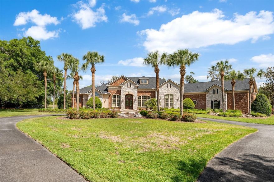 Experience unparalleled luxury in this stunning 5,000+ square-foot home nestled on over 5 acres of meticulously manicured grounds within the exclusive gated community of The Grove. The main floor features European-style Travertine flooring, soaring ceilings, and a thoughtful layout that includes four spacious en-suite bedrooms and a convenient half bath with a French door leading to the pool. The primary suite is a true retreat, featuring a double-sided fireplace shared with a spa-like bathroom, while the first floor also hosts a handsome office with built-in bookshelves and a large entertainment room with French doors that open directly to the outdoor oasis. At the heart of the home, the newly updated gourmet kitchen boasts custom cabinetry, a Sub-Zero refrigerator, a gas range with a second gas oven, and an expansive custom pantry equipped with an additional refrigerator. This culinary space flows seamlessly into the formal living and family rooms—both featuring gas fireplaces—and an adjacent wine bar. Upstairs, you will find a versatile fifth en-suite bedroom, recently remodeled to include a new built-in bar with a beverage refrigerator and abundant closet space, offering a flexible area that can be transformed to suit any need. The exterior is a private sanctuary featuring a sparkling swimming pool, spa, and extensive travertine deck, complemented by an outdoor fireplace, surround sound, and an in-ground trampoline for ultimate enjoyment. Complete with a Control4 Home Automation System, every detail of this home is designed for sophisticated living and modern convenience.