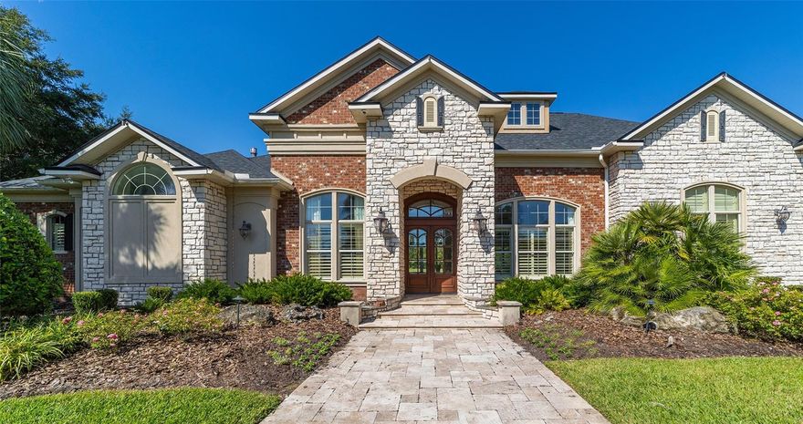 Experience unparalleled luxury in this stunning 5,000+ square-foot home nestled on over 5 acres of meticulously manicured grounds within the exclusive gated community of The Grove. This architectural masterpiece features European-style Travertine flooring throughout the first floor, soaring ceilings adorned with extensive crown molding, and exquisite trey ceiling details. The home boasts four spacious bedrooms, three of which include en-suite bathrooms all on main floor. The primary suite is a true retreat, complete with a double sided fireplace which can also be enjoyed in the spa-like bathroom. An abundance of near floor-to-ceiling windows floods the home with natural light, accentuating the arched doorways and elegant design details throughout. In addition to the 4 bedrooms and 4 bathrooms, the first floor has an half bath with french door to pool area, office with beautiful built-in book shelves and another large room for entertaining. The heart of the home is the expansive, newly updated kitchen, features custom cabinetry, built-in oven and microwave, a second gas oven with gas range, a Sub-Zero refrigerator, and an adjacent wine bar with wine refrigerator, and a large custom designed pantry. It flows seamlessly into the formal living area and family room both with gas fireplaces enhancing the homes warmth and ambiance. Located upstairs is another recently remodeled en-suite with built in bar area, extra closets, and a full bath. This beautiful space can be transformed into anything you heart desires. Step outside to your private oasis, featuring a sparkling swimming pool, spa, and extensive travertine deck. Entertain effortlessly with outdoor surround sound system, a covered patio with a cozy living area by the out door fireplace, and glorious sunsets. The in ground trampoline adds extra fun. Every aspect of this home is thoughtfully designed for both comfort and sophistication, with Control4 Home Automation System providing ultimate modern convenience. Don't miss this opportunity to own a piece of luxury in one of the area's most exclusive communities.