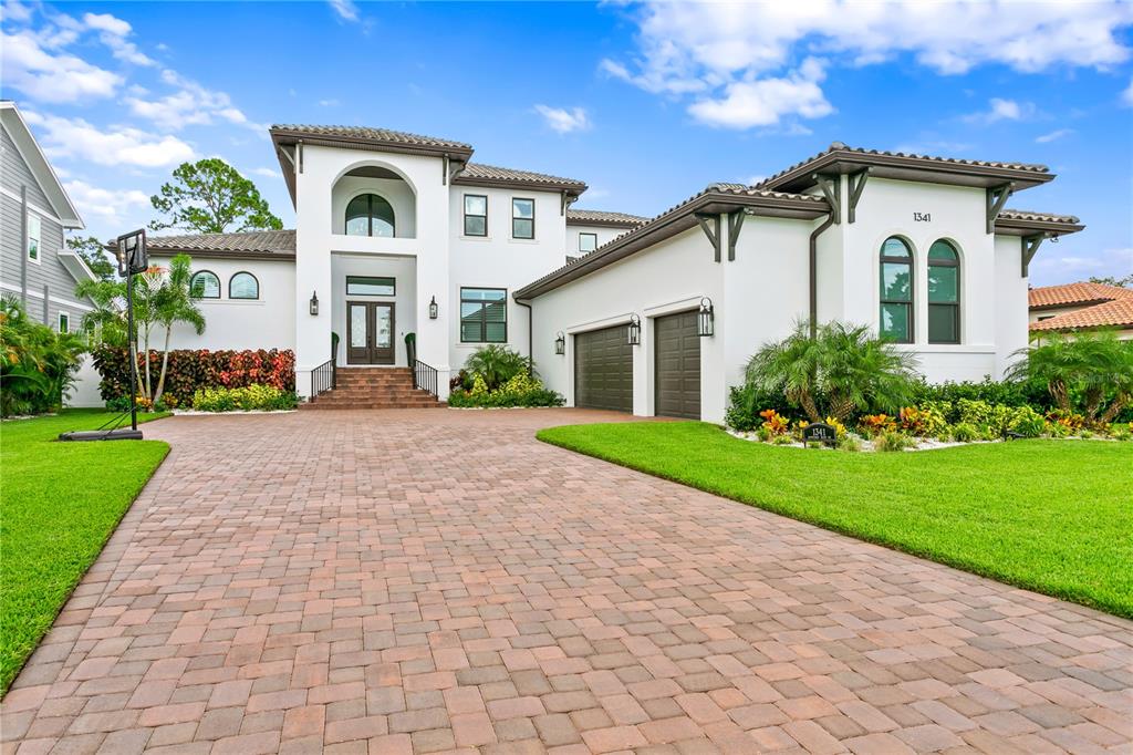 Located on the prestigious Renaissance Vinoy Golf Course, this beautiful 2021 constructed custom home features an amazing view along the 4th fairway. A grand entrance with the large entry foyer and a two story atrium opens to the main living area with coffered 12' ceilings, large plank white oak floors and lots of windows and light facing the course. A true coastal home with an open concept living room, beautiful gourmet kitchen with GE Monogram and Miele appliances, custom cabinetry, an oversized island and dining area with customized extra thick upgraded cambria quartz counters and a bar area with icemaker. Also a pantry and mudroom off the kitchen with lots of storage. The custom built-in entertainment center in the main room has an electric fireplace and opens to the covered patios making it perfect for entertaining for outdoor and indoor creating a mixed living space while the porch features cypress ceiling. Plantation shutters with shades on remote. Owners suite located on the main level as well as guest bedroom and office. Secondary bedrooms are all en suite with great walk-in closets. The backyard is oversized with a Sekas custom built pool 15 x 34 with sun shelf and spa with 8 jets and LED lights. Concrete barrel tile roof, impact rated windows and doors, concrete block construction, whole house generator, 3-car oversized garage, prewired for surround sound, prewired for speakers in living room and outdoor, prewired for smarthome. Turf in the back and side yards. One year builder warranty until 10/2022. Borate termite with an in the wall pest system. And there is so much more! When is the last time there was a new house like this in a location like this? Never!