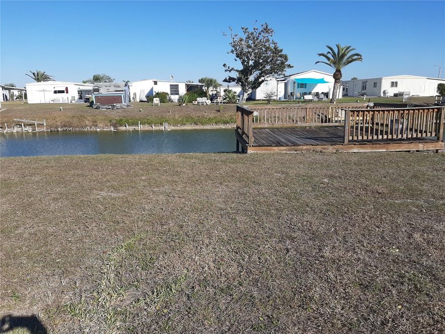 Freshwater Canal w wooden deck for watching your favorite activities. Lots of concrete exists: Driveway, structure pad, carport pad.
