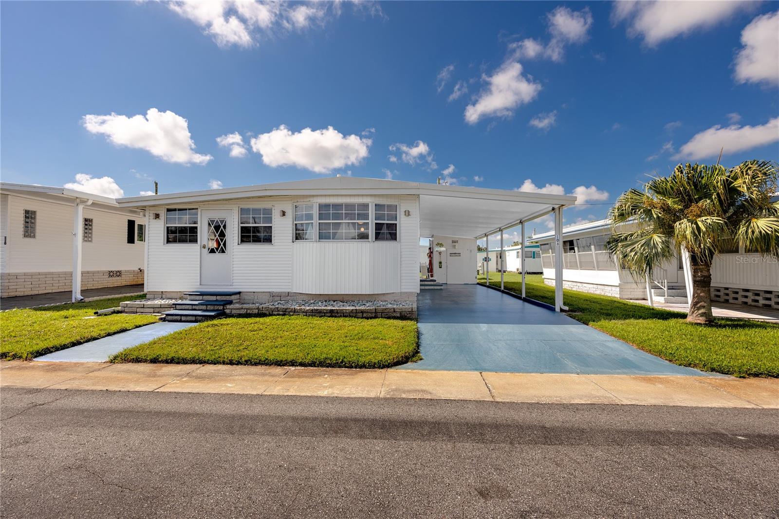 Under contract-accepting backup offers. Welcome to Lake Highlander, an exclusive 55+ resident-owned community in the heart of Dunedin, Florida! This charming double-wide home is offered fully furnished and is tucked away on a quiet cul-de-sac, offering comfort, convenience, and a low-maintenance lifestyle in one of Pinellas County’s most desirable retirement destinations.
Inside, the inviting open-concept layout flows seamlessly with easy-care laminate flooring throughout. A versatile 2nd bedroom room can serve as a home office, craft studio, or guest bedroom, giving you flexibility to match your lifestyle. The home also provides abundant storage, a large covered carport, a separate storage shed with an interior laundry room, plus an additional shed for outdoor storage. For added peace of mind, the roof was replaced in 2019.
Lake Highlander is home to just 289 residences, ensuring a true sense of community with no short-term rentals allowed. Residents enjoy exceptional amenities, including a geothermal heated swimming pool, recreation center with bathrooms and stage, game room with billiards and card tables, community library, laundry center, and six shuffleboard courts. Scenic walking paths surround the lake and fountain, with an observation dock perfect for quiet afternoons by the water.
Monthly HOA fees are just $255 and cover water, sewer, trash, exterior maintenance, and access to all amenities.
Discover a vibrant, welcoming 55+ lifestyle in a beautifully maintained Dunedin community, where comfort and convenience are built into every detail. Schedule your private tour today!