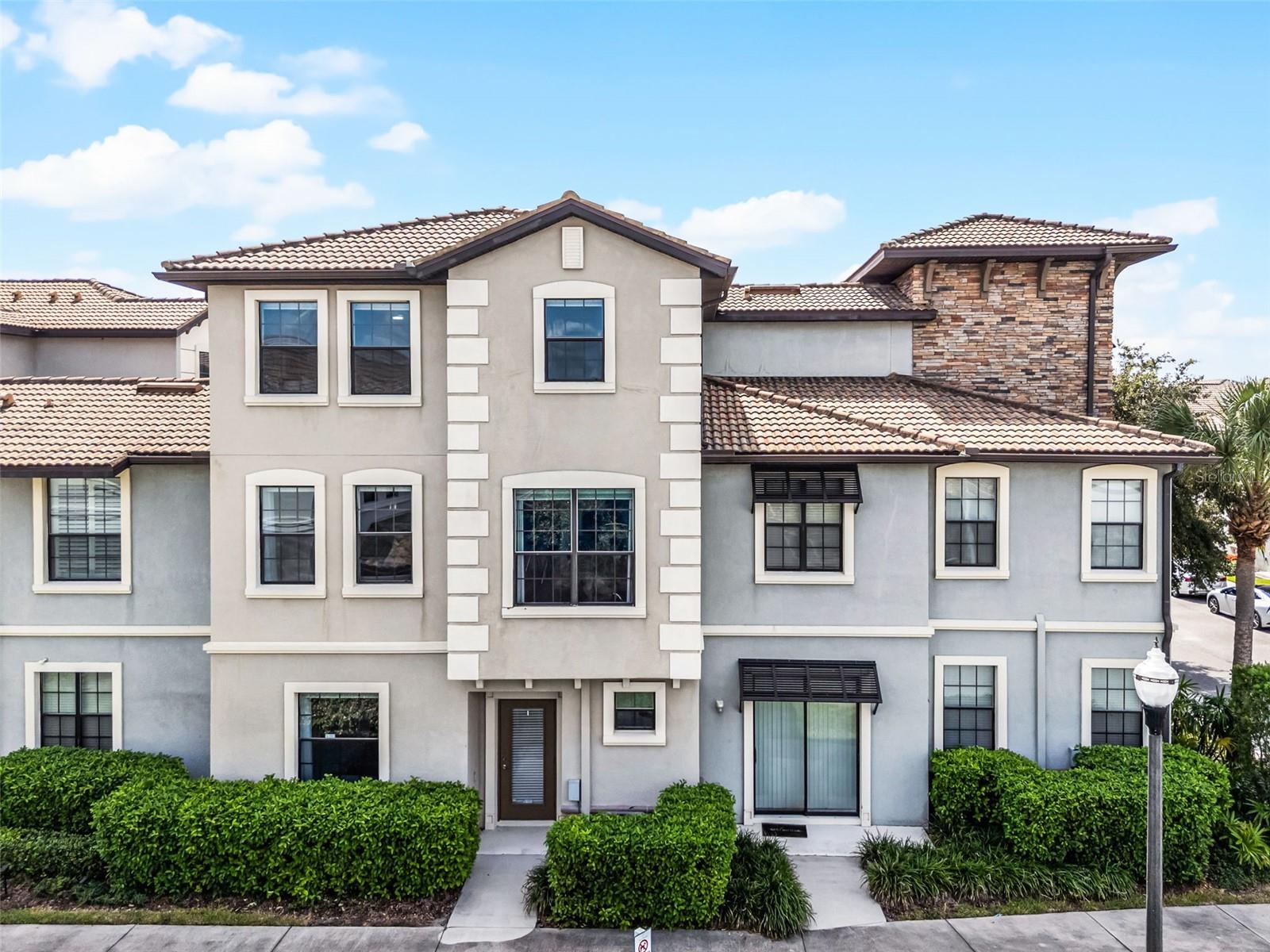 Resort-style living at its finest! This stunning three-story townhome in the highly sought-after Vistas neighborhood of Champions Gate offers the perfect blend of luxury, convenience, and fun—whether you’re looking for a primary residence, vacation retreat, or investment opportunity. Step inside to discover an open and inviting floor plan with 4 spacious bedrooms and 4 full bathrooms, including two master suites with private baths featuring dual sinks, walk-in closets, garden tubs, and separate showers. The second floor boasts a bright, open-concept living and dining area connected to a fully equipped kitchen with granite countertops and stainless steel appliances, ideal for entertaining family and friends. You’ll also enjoy the convenience of an upstairs laundry room and a two-car garage. Living in The Vistas means enjoying exclusive access to world-class amenities. Relax at the resort-style pool and heated spa, unwind in the sauna, play in the game room or golf simulator, or stay active in the state-of-the-art fitness center. Beyond The Vistas Club, residents of Champions Gate have access to two championship golf courses designed by Greg Norman, as well as endless options for dining, shopping, and entertainment just minutes away. Perfectly located just off I-4 at Exit 58, this home provides quick access to 429, 417, and all of Central Florida’s attractions. Walt Disney World, Universal Studios, and International Drive are only a short drive away, and both Orlando and Sanford International Airports are within 45 minutes. Whether you’re relaxing at home, enjoying the amenities, or exploring everything Orlando has to offer, this property delivers a lifestyle that truly feels like a vacation every day.