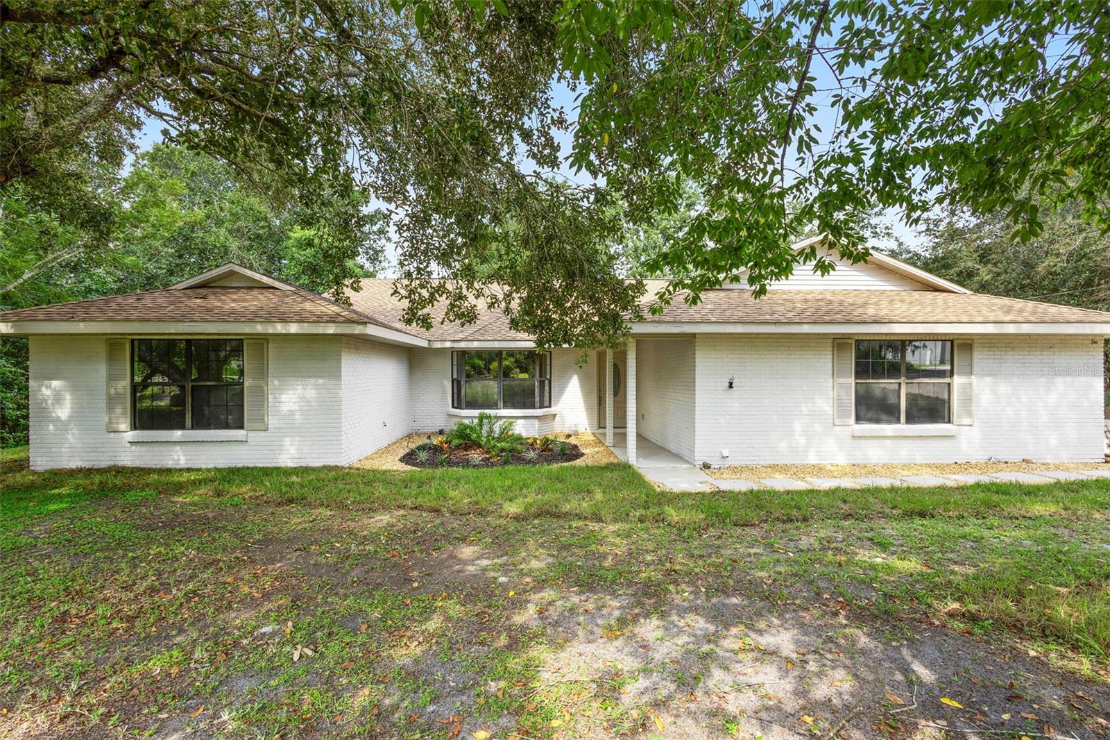 Welcome to your newly renovated retreat nestled in the quiet Orlandia Heights neighborhood. This spacious 3-bedroom, 2-bath home offers comfort, style, and smart functionality across a well-thought-out layout. Enter to find luxury vinyl plank flooring flowing throughout the common areas, with fresh carpeting in the bedrooms for added coziness.
The kitchen steals the show with sleek quartz countertops, stainless steel appliances, brand-new cabinetry, and a striking backsplash. It seamlessly opens to the family room, where a wood-burning fireplace adds a cozy centerpiece for gatherings or quiet nights in. The dining room is just off the kitchen, ready for everything from weeknight dinners to holiday feasts. Looking for a flexible space? The back den is perfect for a home office, additional bedroom, or your very own exercise room—multiple uses possible.
The primary bedroom is a true standout with double French doors opening to the porch and a spa-inspired bath featuring a large walk-in shower and modern finishes. Two secondary bedrooms and a fully updated bathroom round out this thoughtfully updated home.
Outside, enjoy a generous lot that allows for outdoor entertaining, gardening, or simply soaking in the sun. Nearby community perks include a local park, grocery store, and the DeBary Sunrail Station—all just minutes away—making everyday errands and commuting a breeze.
Whether you're looking to work, relax, or get your hands dirty in the garden, this home offers a fresh start in all the best ways.