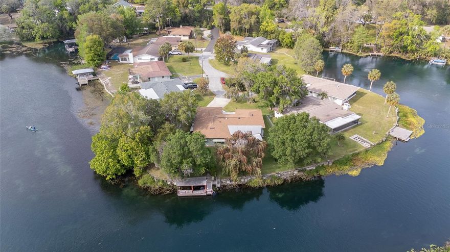 This classic WATERFRONT home is perfectly situated along the stunning banks of the Rainbow River in downtown Dunnellon, Florida. Upon entering, your eyes are immediately drawn to the crystal-clear water beyond the lanai, where you can envision yourself sipping morning coffee while enjoying the soothing sounds of nature and watching the sun's golden rays dance upon the water in the early dawn. Spanning a generous 2,162 square feet of interior living space and about 135 feet of waterfrontage, this home radiates potential and allure, eagerly awaiting new owners to revive it and make it their own!  This 4-bedroom, 2.5-bathroom, 2-car garage home has ample space for family and friends to enjoy multiple private and shared living areas with breathtaking views of the Rainbow throughout. Its 1973 vintage “Old Florida” charm echoes a familiar architectural style often seen along the river. Yes, it needs updating, but its layout is the perfect canvas for crafting a personal haven that mirrors your unique style and vision. This home sits on a very comfortable .26-acre parcel, with several gorgeous bottle brush trees around the home, blooming red blossoms intermittently throughout the year.  With the roof and HVAC system updated in 2019, the rest of the home presents a blank slate for your imagination, poised to transform into a sanctuary where cherished memories are forged.  Best of all, this home is situated across from a nature preserve, providing a lifetime of privacy across the way! For those unfamiliar with the Rainbow, the water is 72 degrees year-round and sourced from a First Magnitude Spring flowing from Rainbow Springs State Park, pumping over 400 million gallons of fresh spring water daily. This gives you about 5.7 miles of unique crystal-clear water for swimming, boating, tubing, and paddling adventures until it converges with the Withlacoochee River, which offers many more miles of exploration without ever getting bored with the same scenery! Just want to chill? Fish right off the dock, birdwatch, host barbecues, or simply relax in the radiant afternoon sun. Feel the need to explore more? This home is centrally located to local restaurants, shopping, amenities, and parks. It is also directly across from the Dunnellon Nature/Bike Trail, which leads to the Withlacoochee Trail - a sought-after destination for outdoor enthusiasts, giving you about 46 miles of outside adventure, and allowing you to traverse some of Florida's most unique forests and wetlands. This home is also within 30 minutes of Ocala and the World Equestrian Center, about an hour from Gainesville, and less than two hours from Orlando and Tampa airports, theme parks, and some of Florida's best beaches. Seize this opportunity to breathe new life into this lovely dwelling along the Rainbow River, and create the dream home or vacation retreat you’ve always envisioned! Let the adventure begin, and call today to set your appointment!