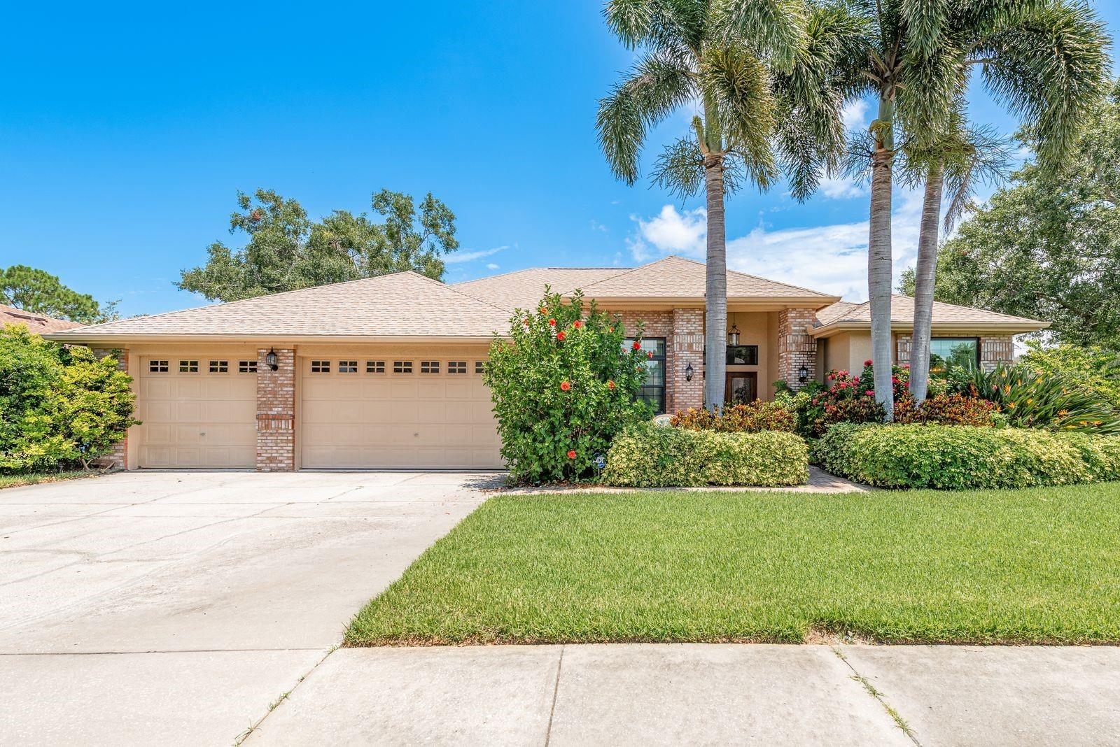 Welcome to 1843 Barn Owl Way – your chance to own a beautifully updated, move-in ready home in one of Palm Harbor’s most desirable neighborhoods, Pipers Meadow. Situated on a generous .38-acre corner lot, this 2,567sf residence offers 4 bedrooms, 3 bathrooms, a 3-car garage, and an incredible screened-in saltwater & solar heater pool! From the moment you arrive, you'll be captivated by the lush landscaping, including a majestic oak tree and tall palms that frame the home’s charming front sitting area. A brick-paver entry leads you to elegant glass leaded double doors, setting the tone for the refined interior. Step inside to discover a spacious 3-way split floor plan featuring high ceilings, crown molding, and engineered hardwood floors throughout. The formal living and dining areas are filled with natural light and feature built-in shelving, perfect for both display and storage. The heart of the home is the gourmet kitchen, boasting cream cabinetry with designer trim, tile backsplash, granite countertops, and stainless steel appliances, including a double dishwasher. A reverse osmosis system adds convenience, and a breakfast bar seamlessly connects the kitchen to the sunny dining nook and oversized family room. The family room impresses with high ceilings, a wood-burning stone fireplace, and sliding glass doors that open to the lanai. The primary suite is a tranquil retreat with lanai views and an extra bonus area ideal for a home office or cozy reading nook. The suite includes two walk-in closets and a luxuriously renovated en-suite bathroom with quartz countertops, a soaking tub, frameless glass shower, and private commode. The opposite side of the home houses two spacious guest bedrooms sharing a beautifully refreshed guest bathroom! The fourth ensuite bedroom is at the back of the house with a private bathroom that exits to the pool! From most rooms you can step outside to enjoy your private screened-in lanai with newer pebble flooring! Enjoy the all-year solar heated & salt water pool. Additional upgraded features include: Updated electrical panel with subpanel for generator, whole-house water filtration system, 2017 HVAC and 2008 roof, hurricane-force windows and hurricane screen for back porch area (sliding doors). Located in Flood Zone X/Non-Evacuation Zone!!! Connected to Reclaimed Water for irrigation! Pipers Meadow is a vibrant, friendly community offering fun events like block parties, holiday light trolley tour, and Bunco nights. Zoned for top-rated Palm Harbor schools, including Palm Harbor University High School, and just minutes from award-winning beaches, the Pinellas Trail, golf courses, shopping, and medical facilities. This home is stunning and a MUST SEE!!!