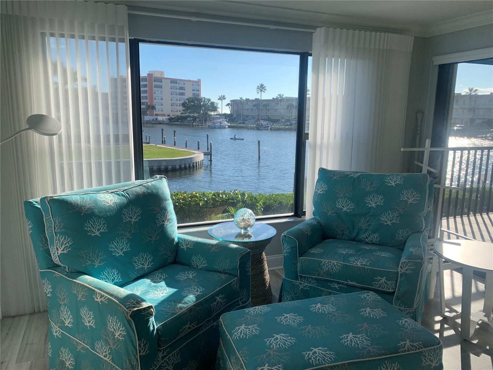 Gorgeous waterfront condo at The Moorings! You will love the view and the comforts of this well decorated condo in a coastal theme with a stunning view of Blind Pass Intercoastal and a partial view of the Gulf of Mexico just beyond. This community consists of just 17 condos and is on the quieter southern end of Siesta Key. Enjoy your private boat slip or just fish off the dock. Primary bedroom has customized storage and closet area and features a king-sized bed. Beautiful ensuite bathroom is remodeled and updated, as is the guest bath. This space also opens up to the screened in 12 x 10 balcony overlooking the water where there are usually kayakers and paddleboarders. The second bedroom has a queen and a twin bed. You will love the kitchen and eating your meals from bar area where you can view out your large living room window with electric shades. For your convenience, The Siesta Key Trolley, which is a constant running free "hop on" and "hop off" way to get to other areas on the Key, that stops right in from on Midnight Pass Rd. Repeat guest cannot return and this beautiful vacation property just opened up.