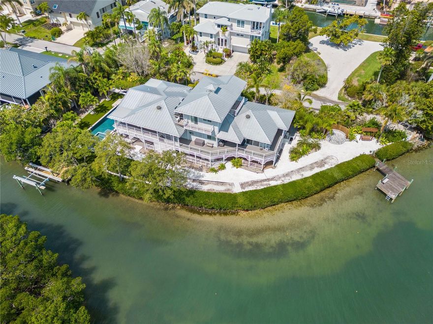 Nestled in the North Longboat Key area, this stunning five-bedroom home rebuilt in 2014 with new pool and many other features offers unparalleled luxury and breathtaking views. As you step through the sliding glass doors from the main living area to the terrace, you are greeted by the expansive vistas of Sarasota Bay and the Intercoastal Waterway. This property is an epitome of modern elegance, featuring high-end finishes and an array of amenities designed for comfort and style. Key features of the home include a gourmet kitchen equipped with the latest high end appliances ideal for culinary enthusiasts. The home has been recently updated with modern touches throughout plus a new roof. The four bathrooms are newly renovated with premium fixtures. The home has an elevator that accesses all levels. The spacious three car garage ensures plenty of room for vehicles and storage.The outdoor oasis features a hot tub and heated swimming pool, outdoor grill and under cover sitting perfect for unwinding and entertaining. For the boater two docks are on the property one with a 10,000 pound lift. Imagine waking up to the serene beauty of Sarasota Bay every morning. This home offers a unique living experience where nature and luxury intertwine. Whether you are entertaining guests or enjoying a quiet evening with family, the seamless indoor-outdoor living spaces provide a perfect backdrop. The hardwood floors add a touch of warmth, while the high-end finishes ensure an ambiance throughout.
This North Longboat property is a must see for anyone seeking a luxurious lifestyle combined with natural beauty. With its modern amenities, prime location, and stunning views, it stands out as a dream home. Don’t miss the opportunity to make this exquisite residence your own.This north Longboat location is near many outstanding restaurants and Anna Maria Island. The azure waters of the Gulf of Mexico and the beach are just steps away.