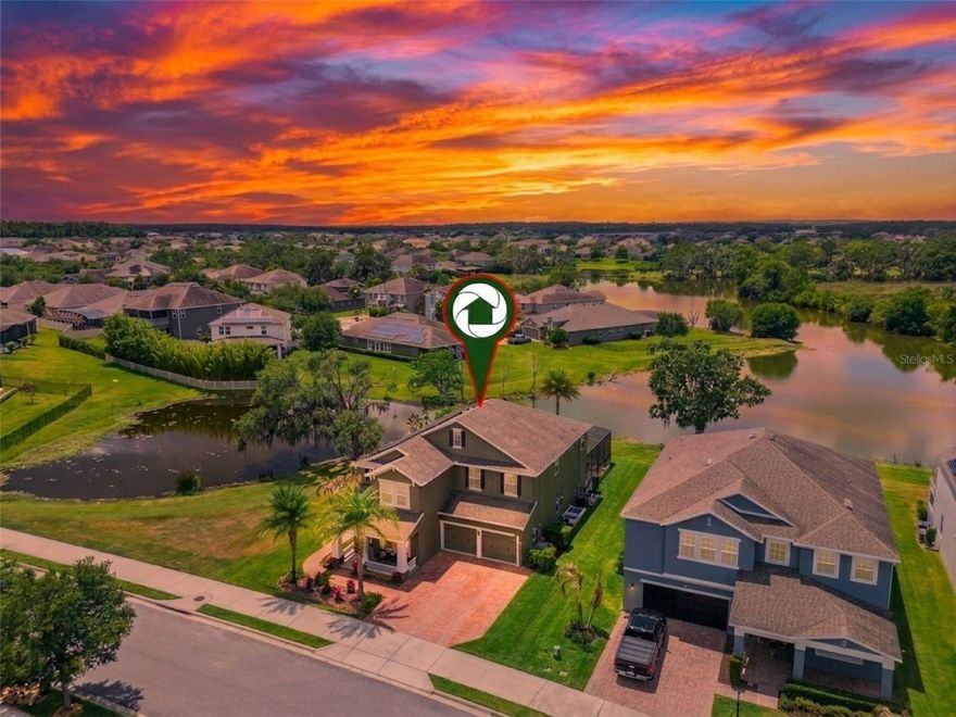 One lucky buyer will soon call this exceptional home their own. Proudly offered for the first time by the original owners, who have cherished and meticulously cared for it since day one, this residence sits on a quiet cul-de-sac in the gated community of Hickory Hammock. With generous 90 feet of frontage along Lake Burnett and bordered by a retention pond on the side, it delivers rare privacy and space that is seldom found at this price point in the area.
Curb appeal greets you immediately on this peaceful Cul de sac surrounded by stocked ponds, setting the stage for one “wow” moment after another inside. Formal living and dining areas welcome you, with the flexible living space easily convertible to a home office with minimal effort. The heart of the home is the expansive open kitchen, complete with abundant counter space, a large prep island, and a walk-in pantry. Even routine tasks become a pleasure here, thanks to the sweeping views of the backyard oasis from the sink.
Adjacent, the oversized family room features a dramatic wall of glass that frames the breathtaking scenery beyond. Upstairs, a spacious bonus room offers versatility, pre-wired for a home theater. The owner’s suite is huge with  dual vanities, a walk-in shower,  a soothing garden tub and 2 walk in closets.
Yet it is the backyard that truly captures the essence of the Florida lifestyle. A large screened and heated saltwater pool  anchors the space, surrounded by a beautifully finished deck perfect for effortless entertaining or quiet relaxation after a long day. From here, postcard-perfect sunsets paint the sky while you soak in panoramic views of Lake Burnett, Johns Lake, and the serene nature preserve—views that feel exclusively yours thanks to the thoughtful layout and surrounding privacy. The hot tub will stay too !  New pool pump too.

The FULLY PAID -OFF whole-home solar panel system ensures your electric bills remain remarkably low, while an EV charger, upgraded shutters on all windows and overhead garage storage racks convey with the home. Whole home water filtration will also stay. Both AC units replaced 2 years ago and come with 10 year warranties, for worry free ownership.

Residents of Hickory Hammock enjoy a true resort lifestyle behind the gated entrance. Gather at the clubhouse, unwind by the beach-entry community pool, or stay active at the state-of-the-art fitness center, tennis courts, playground, beach volleyball area, BBQ and picnic spots, lakeside park, and fishing pier along Johns Lake.
Highly rated K-12 school district ,  and convenient access to Montverde Academy, Foundation Academy and Windermere Preparatory campuses, make this an ideal location for those that are focused on education. Everyday conveniences abound with shopping and dining options in every direction, including a short drive to Winter Garden Village and the vibrant historic downtown with its famous farmers market and year round festivals. Disney is less than 20 minutes from the gate, downtown Orlando is easily reachable, and the 429 expressway provides smooth commutes throughout Central Florida.
This is a rare opportunity to own a lovingly maintained home with unmatched privacy, sweeping lake and preserve views, and an enviable lifestyle—all priced for a smooth, no-drama transaction. Don’t miss your chance to experience it in person.