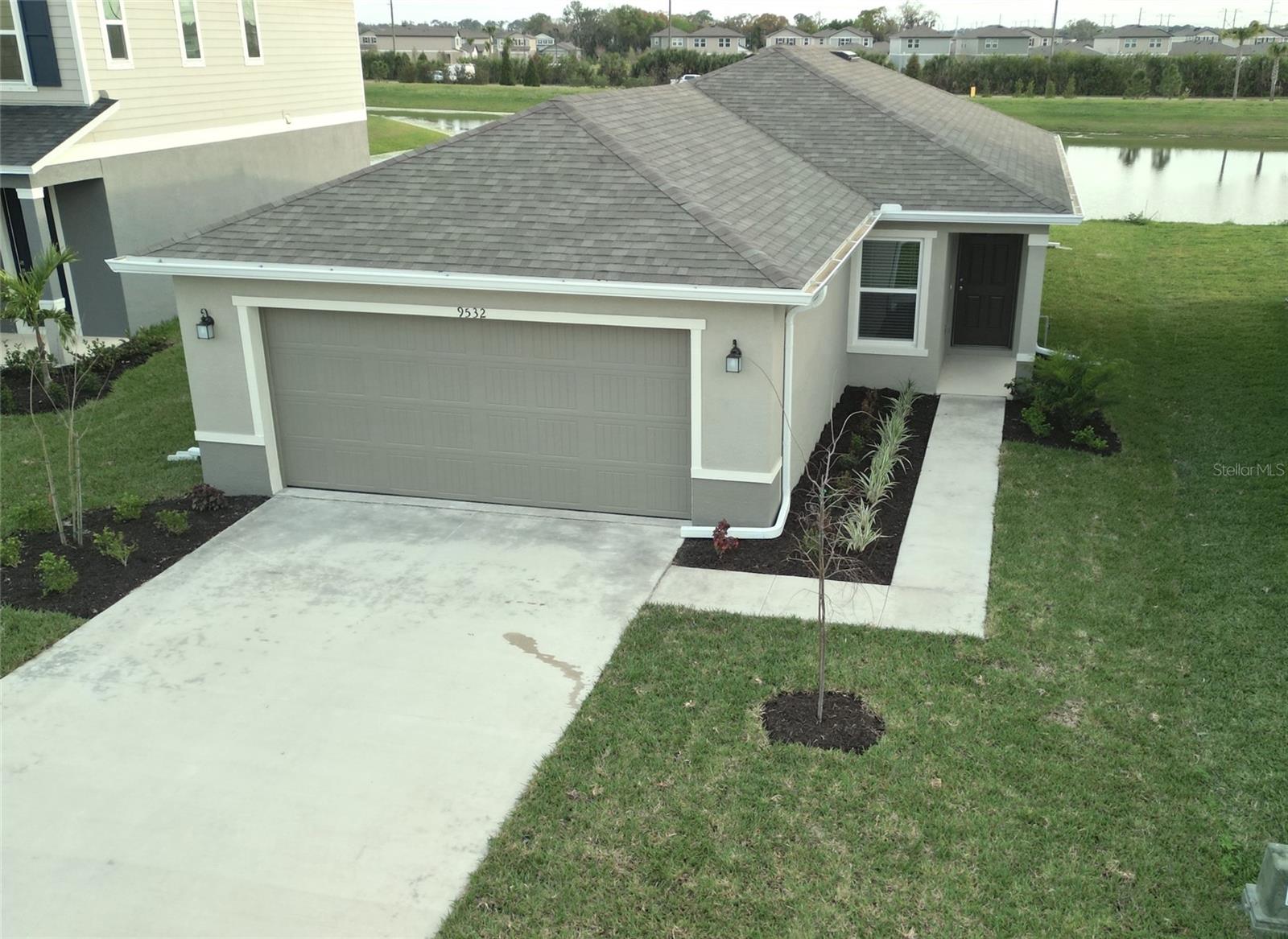 Almost new waterfront home with a screened lanai! Wide lake view with no homes across the water. Located just 1/2 block from the neighborhood resort beach-entry pool, cabanas and tot lot. The open floor plan starts with a spacious great room, volume ceilings and 18 inch tile in the living areas. The kitchen includes Whirlpool stainless appliances, granite counter tops, a breakfast bar, and pantry. Main bedroom has a walk-in closet, bath has a duel sink vanity with a granite counter top and a walk-in shower. Washer and dryer are included in the dedicated laundry room. Screened lanai with open water view. Lawn care is provided. This is in a great location: Close to I-75, US-41 and US-301, just a short drive to shopping, dining and entertainment along US-41. Close proximity to some of Florida's most pristine beaches, including Siesta Key, Longboat Key, Lido Key, Holmes and Bradenton Beach. Minutes to Ellenton Premium Outlets for shopping and dining. Zoned for School District of Manatee County, which includes Barbara A. Harvey Elementary, Parrish Charter Academy and Parrish Community High School. Enjoy maintenance-free living in this new home!