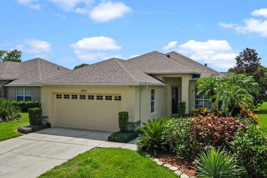 From the moment you arrive, you'll be charmed by the lush landscaping with graceful palms and vibrant foliage that set the tone for what's inside: upscale comfort and relaxed luxury. Tucked inside a gated community with a tranquil pond view, this stunning one-story home offers a beautiful blend of elegance, ease, and Florida charm. Bonus: lawn care is included, so you’re free to travel or simply relax.
Step through the stunning 8-foot front door and be swept away by 10-foot ceilings, architectural arches, crown molding, plantation shutters and custom built-ins. Rich wood flooring throughout the living areas, kitchen and bay-window dinette (absolutely no carpet anywhere!) give the home a polished, designer feel. Recessed and ceiling-fan lighting add warmth and ambiance to every room.
The chef-inspired kitchen is a showstopper, boasting 42-inch upper cabinets with crowns and mullion glass fronts for display, plus granite countertops that stretch on and on. A deep double sink looks into the living room—perfect for catching the game while prepping meals. With a Lazy Susan, cabinet pantry, breakfast bar, and eye-catching backsplash, the kitchen blends function and flair with ease.
Slide open the triple 8-foot glass doors and take a comfy seat on your screened lanai with motorized rolled shade. Watch morning birds glide across the pond and witness stunning sunsets every night. It’s peaceful, private, and perfect.
The primary suite is a true retreat. Unwind in the corner soaking tub surrounded by a decorative backsplash and bathed in natural light from a privacy-glass block window. A separate floor-to-ceiling tiled shower, chandelier lighting, and a granite double-sink vanity with ample storage complete this luxurious space. A 12-foot deep closet and sun-filtering shutters add both comfort and function.
Guests will love the private in-law suite setup—a second bedroom with direct access to the hall bath, complete with granite vanity, easy-clean undermount sink, and built-in medicine cabinet. The third bedroom is a multifunctional gem with custom shelving and cabinetry—it's like an inside-out CA closet with built-in desk!
And it gets even better: new roof, water heater, and freshly painted exterior in 2021. All-around gutters: check! Private mailbox: check! Oversized two-car garage with generous storage shelving: check!
Take your golf cart or stroll to the nearby vacation-style amenities that include a clubhouse with fitness equipment and full-kitchen event space, sparkling pool and spa, dog run, tennis/pickleball court, and fishing pier.
Within 10 minutes are restaurants, grocery and home stores, shopping centers. Take advantage of Lakeland's multiple golf courses, hiking/nature trails, lakes, and entertainment venues. Nestled between the Gulf and Atlantic beaches, plus near the world's most famous theme parks and international airports, you can live as active or relaxed as you desire at 6555 Lake Clark Drive.
This isn’t just a home—it’s a lifestyle. And it’s waiting for you...But not for long!