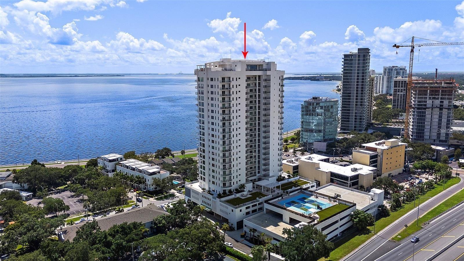Welcome to Altura Bayshore, where refined living meets modern convenience. Located at 2910 W Barcelona St, this meticulously crafted residence sets the standard for upscale urban living with beautiful views of Hillsborough Bay, Bayshore Blvd, and South Tampa.
Step into a stunning open-concept floor plan designed for comfort and sophistication with Floor-to-ceiling windows, flexible great room with large sliders to a private balcony. “A chef’s delight” describes this kitchen, featuring state-of-the-art Thermador appliances and high-end finishes—perfect for day to day cooking, intimate gatherings and grand entertaining. The split floorplan allows for private primary bedroom to get away from the two secondary bedrooms and a flex room as a fourth bedroom, den or office. Indulge in a the amazing amenities designed to elevate your lifestyle. The rooftop pool offers panoramic city views, while a cutting-edge fitness center, bocce ball court, pickleball court, and mini golf provide ample opportunities for recreation. Enjoy the convenience of the outdoor grilling area for your personal dining or stay and enjoy an al fresco meal with the elegant lounge seating. Pet owners will appreciate the dedicated dog run, and visiting guests will enjoy the comfort and privacy of well-appointed guest suites. More than just a home it is a statement of luxury and a retreat for those who value the finer things in life. Schedule your private tour today and experience the exceptional lifestyle that awaits at Altura Bayshore.