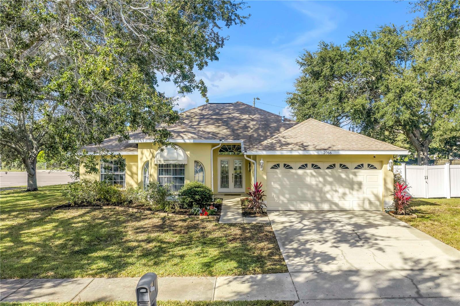 Welcome to this beautifully maintained 3-bedroom, 2-bathroom, 2-car garage pool home in desirable Dunedin.  Built in 2001 with solid block construction, this home sits gracefully beneath the shade of mature oak trees on a spacious 120’ x 110’ corner lot.
As you arrive, you’ll appreciate the home’s curb appeal, enhanced by thoughtful landscaping and ample yard space.  Step through the French front doors into the main living area, where elevated ceilings, engineered hardwood floors, and an abundance of natural light flowing through the open-concept design create a warm, inviting atmosphere.
The split floor plan offers privacy and functionality.  The primary suite sets a spacious tone with its vaulted ceiling, generous walk-in closet, private lanai access, and updated ensuite bath featuring a walk-in shower.  Just across the home, two comfortable guest bedrooms and a guest bath provide a relaxing retreat for family or visitors.
Continue through to the heart of the home, the kitchen, recently refreshed with painted cabinetry, granite countertops, stainless steel appliances, and a convenient breakfast bar, perfect for morning coffee or casual dining.  Adjacent to the kitchen, the flexible dining area and second living space offer versatility for entertaining, working from home, or relaxing with family.
Standout feature is the accessibility to the enclosed salt water pool area from the living and dining areas.  The pool was resurfaced in 2021, and the expansive side yard offers a blank canvas to create your own outdoor oasis or garden retreat.  Additional updates include a new roof (2019), HVAC (2021), Vivint smart security system with smoke detectors, gutter covers and drainage upgrades.
While conveniently located offering quick access to shops, dining, and entertainment.  Just minutes from Downtown Dunedin, Honeymoon Island’s pristine beaches, and local piers and marinas, this home truly captures the best of the Dunedin lifestyle.