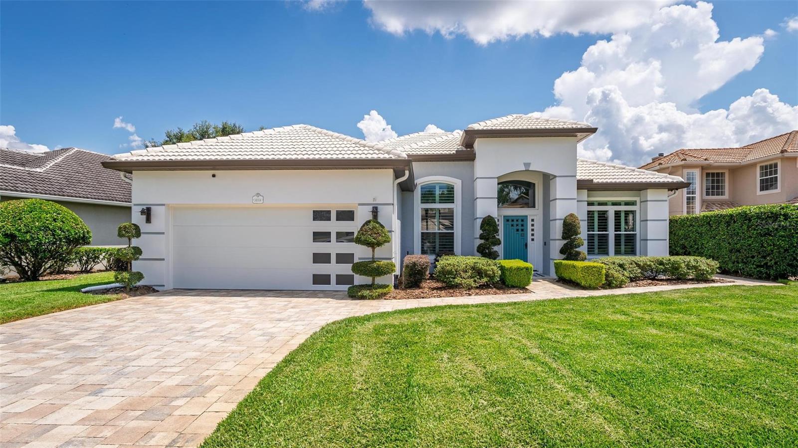 First time on the market! This one-owner St. Andrews Model pool home has been meticulously maintained and showcases a blend of modern design and timeless style.
From the moment you arrive, the curb appeal stands out with a paver driveway and sidewalk framed by reinforced concrete borders, a manicured lawn, elegant topiary plantings, and trimmed box hedges. A custom front door complements the updated garage door with mid-century flair. In the backyard, you’ll enjoy tranquil views of the large pond and fountain, framed by Rubellini palms and lush, tasteful landscaping.
Step inside to find an inviting formal dining room and a versatile living room, currently used as an office. Volume ceilings and a striking three-sided gas fireplace create warmth and character, while the spacious family room opens seamlessly to the lanai and sparkling screened pool—perfect for entertaining. The bright kitchen features light cabinetry, a subway tile backsplash, stainless steel appliances, and a cozy breakfast nook with views of the pool and backyard.
The popular split-bedroom layout offers privacy for all. The primary suite, located just off the kitchen, boasts a sitting area ideal for reading or relaxing, with direct access to the pool and serene backyard views. The ensuite bath includes a large walk-in shower, deep soaking tub, dual sinks with a vanity area, and a walk-in closet with custom built-ins and stylish accent doors. Two additional bedrooms on the opposite side of the home share a full bath and linen storage, while one guest room at the front of the home offers extra privacy.
This community makes maintenance easy with HOA-provided lawn care (mowing, trimming, fertilization, and hedge work), irrigation, and exterior house painting every nine years. Residents also enjoy access to a dedicated storage lot for boats or RVs, high-speed fiber optic service, and a prime location adjacent to the private West Orange County Country Club.
With unbeatable amenities, thoughtful details throughout, and a rare first-time offering, this home truly has it all. Schedule your private tour today!