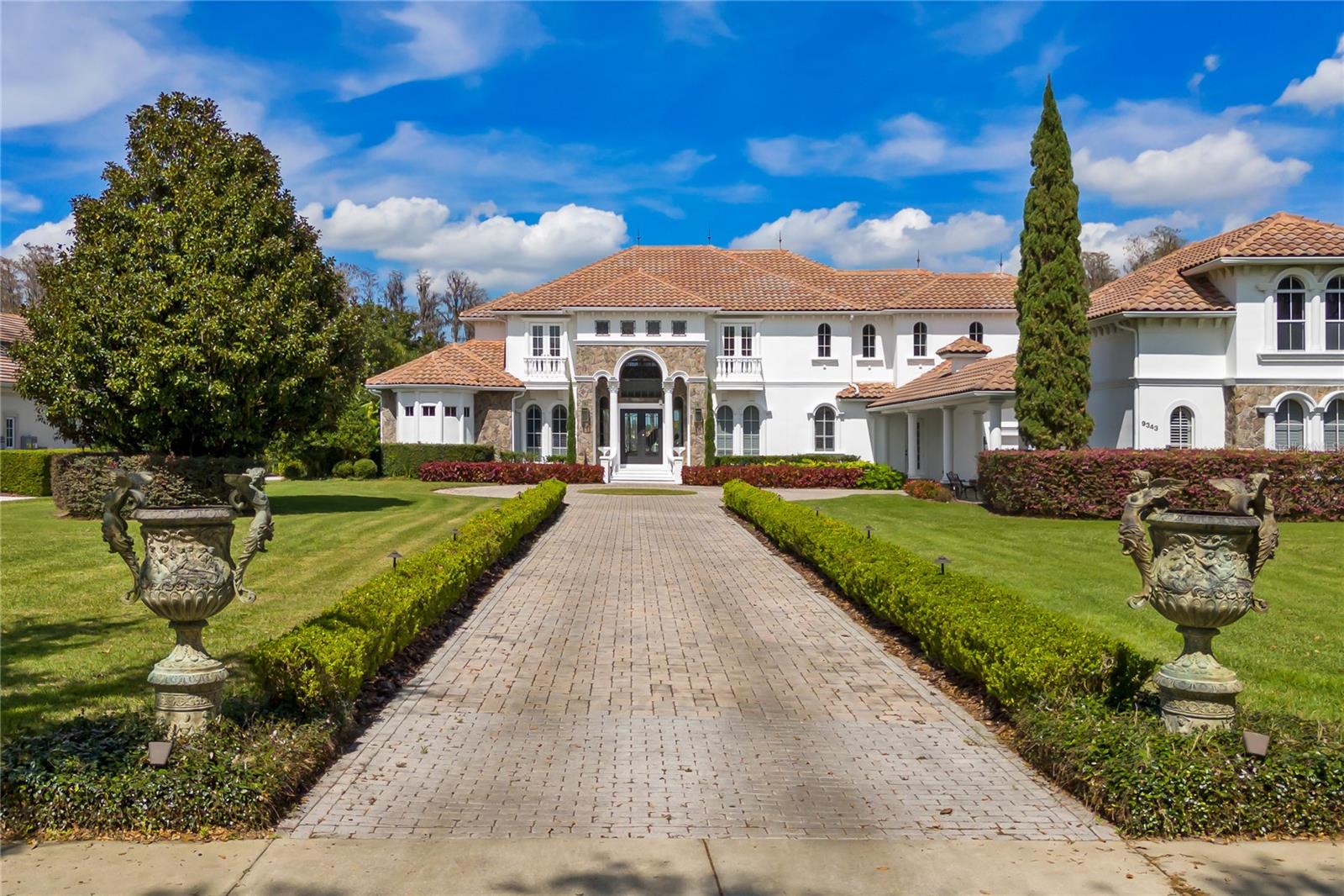 PRICE IMPROVEMENT!!
Perfectly sited on pristine Lake Tibet in Keene's Pointe Country Club, this stunning lakefront Stonebridge custom home has been completely
updated. The modern exterior color brightens the façade and creates a unique transitional style. The wrought iron and glass doors add a refined entry. Opening to the two-story formal areas featuring timeless elements of stone flooring, elegant ceiling details, clerestory windows, and expansive lake views set a modern tone. At the center of the home, the kitchen is a chef's dream; stone flooring and a massive working island, state-of-the-art appliances combine function and beauty with double ovens, exotic granite, stunning glazed custom cabinetry, and a huge walk-in pantry. The gourmet kitchen opens naturally to the family gathering areas, complete with sparkling lake views. A fireplace shares the media wall with a built-in entertainment center, while French doors give access to the outdoors. Just off the family area, the game room is finished with a beautiful bar area. The state-of-the-art home theatre is located just off the game room. Entertain outdoors in true Florida style; the outdoor gourmet area was added in 2019, including a large bbq grill area, massive dining/working island, wine cooler, XL Fridge as well as a pizza oven. The free-form pool, heated spa, and boat dock with lift. The master suite is private with huge master closet and beautifully finished master bath. All secondary bedrooms are ensuite. All baths have been updated. The entire
home has been freshly painted and all carpet has been replaced. The detached guest house is great for extended family.