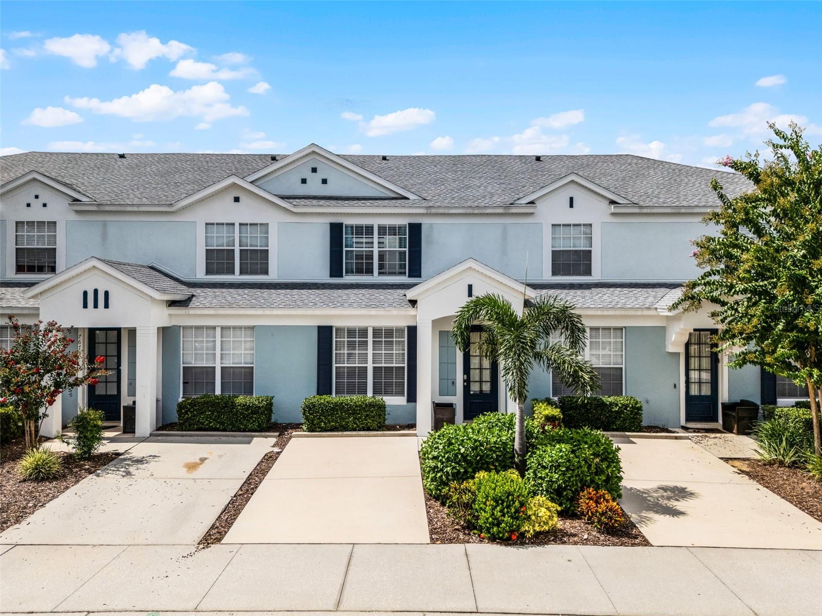 Welcome to this fully furnished, turn-key townhome located in the highly desirable, resort-style Windsor Hills community just 10 minutes from Walt Disney World. This 3-bedroom, 3-bathroom home spans 1,440 square feet and offers the perfect blend of comfort, functionality, and investment potential. Whether you're searching for a short-term vacation rental, second home, or primary residence, this property checks all the boxes. Inside, a bright and spacious open-concept layout combines the living room, dining area, and kitchen, all overlooking a full wall of sliding glass doors that open to a private screened courtyard. This outdoor space features a rare and inviting heated plunge pool with a brick paver patio, offering a peaceful and private setting for entertaining or relaxing after a day at the parks. The layout includes one bedroom with an ensuite bath on the main level, ideal for guests or multigenerational living. Upstairs, two more generously sized bedrooms each feature their own ensuite bathrooms and walk-in closets, providing privacy and comfort for everyone. The kitchen is fully equipped and styled with light gray cabinetry, stainless steel appliances, and modern finishes. The home comes complete with upscale furniture, including newer sofas, and a fully stocked setup ready for rental or personal use. Additional interior features include quartz counters in all bathrooms, a laundry closet with a stacked washer and dryer, an owner’s closet for private storage, a smart thermostat, and hard surface flooring throughout. Wood-look laminate floors accent the bedrooms and upstairs areas, while easy-to-maintain ceramic tile floors cover the main living areas. Recent updates include a new roof installed in 2016 and a recently resurfaced plunge pool. The property is in excellent condition and ready for immediate occupancy or rental. The Windsor Hills community offers unmatched amenities, including a 24-hour guarded gatehouse, a 140,000-gallon lagoon-style swimming pool, hot tub, water park with slides and splash features, clubhouse with movie theater, fitness center, game room, sundry shop, and on-site dining. Outdoor amenities include basketball and tennis courts, a beach volleyball court, playgrounds, putting green, and RV parking area. Monthly HOA dues cover lawn maintenance, landscaping, irrigation, cable TV, high-speed internet, pest control, and waste removal, making this a low-maintenance, high-reward opportunity. Whether you plan to use it as a personal getaway or maximize its short-term rental potential, this townhouse is your gateway to year-round sunshine, unforgettable vacations, and worry-free ownership in one of the most sought-after resort communities near Disney.
