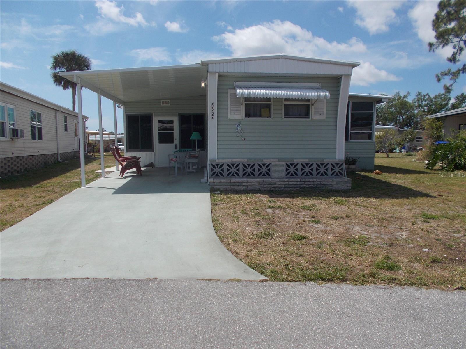 Lovely 2 bedroom, 2 bath furnished home in the 55+ Gated Community of Holiday Park, not in the PET SECTION. This home boasts brand new luxury vinyl flooring on 3/4-inch plywood throughout the main section of the home. It also has a very large recently re-screened lanai with Hurricane Windows and ceramic tile flooring for entertaining needs. At the end of the lanai, you have your utility room that has your washer and dryer. The lanai also has a queen sleeper couch for your overnight guests. This home also has a Florida Room which bumps off of the Living Room. This Florida Room has a wall AC unit and a beautiful heater for those cool nights. This home has a split floor plan with the Master Bedroom in the back of the house. You have an eat-in kitchen and a newer refrigerator. In 2019 a re-pipe was done from under the house to the street. In Holiday Park you own the land with a deed and the of $195.00 ($2340 a year) is included in your taxes. The community features two clubhouses, two swimming pools, a library, a fitness center, tennis courts, pickleball & bocce courts to name a few. You are close to shopping, dining, entertainment, numerous golf courses, sports facilities and SW Florida's world-renowned beaches. Come take a look!