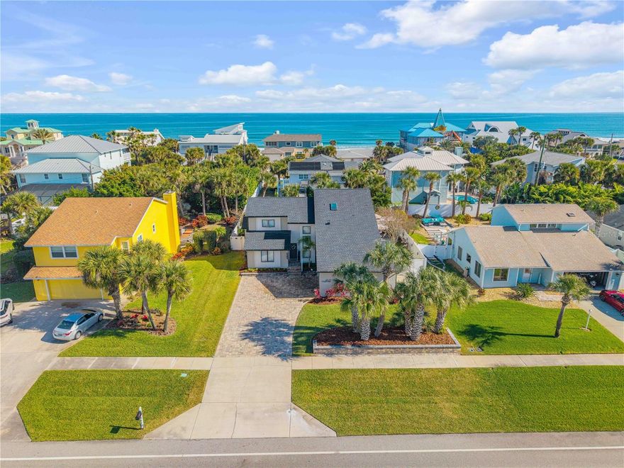 This 4-bedroom, 4.5-bath beachside home is located east of A1A (Atlantic) and offers a short easy walk to the ocean. Designed for entertaining, family fun, or private relaxation, the outdoor living space features resort-like unmatched elegance. Amenities include an outdoor gas firepit, bar, putting green, and a large, newly resurfaced pool with a relaxing sun shelf. The property also includes a paver pool deck and driveway, custom landscape retention walls, and lush tropical landscaping.

The interior open floor plan features a wood-burning fireplace, soaring vaulted ceilings, and a kitchen island bar. The updated kitchen includes granite counters, a farmhouse sink, updated lighting, stainless steel appliances, and ample space for entertaining. A butler’s pantry offers additional storage and a coffee bar, along with an attached laundry area and powder bathroom. There are two downstairs bedrooms with Jack N' Jill bathrooms.

A semi-spiral staircase leads upstairs to the owner’s retreat, which includes a large en-suite bath with a soaking tub, separate shower, and walk-in closet. Sliders open to a private glassed sunroom. Also upstairs is the fourth bedroom with its own attached bath and a loft space suitable for an office or reading area.

Exterior updates include fresh paint, a roof (2025), hot water heater, two A/C units, updated electrical with generator hookup, hurricane shutters, soffits and gutters. The pull-through garage features 9-foot doors on each side, suitable for a boat, golf cart, or additional storage.

This home is a must-see.