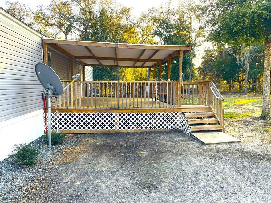 This move-in ready manufactured home is located only 20 minutes from The World Equestrian Center and 15 minutes to Rainbow Springs State Park with easy commute to Ocala and Dunnellon. The property sits on 1.12 acres, all cleared,  fully fenced and gated.  The Delight model by Clayton Homes features 2 bedrooms,  2 baths with ample living space, a fully equipped kitchen with plenty of counter space, wood cabinetry, breakfast bar, an inside laundry room for convenience and LVT flooring thoughout for easy maintenance. The extended back porch is ideal for entertaining and relaxation. Home was built in 2023 and meticously kept. The property is zoned A1 for Agriculture, bring your animals, RV or toys. A large chicken coup and carport is available or can be removed.