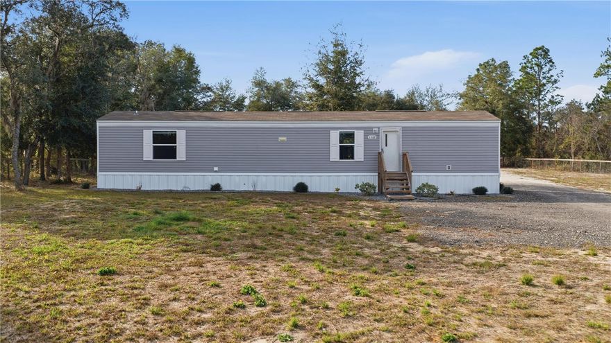 This move-in ready manufactured home is located only 20 minutes from The World Equestrian Center and 15 minutes to Rainbow Springs State Park with easy commute to Ocala and Dunnellon. The property sits on 1.12 acres, all cleared,  fully fenced and gated.  The Delight model by Clayton Homes features 2 bedrooms,  2 baths with ample living space, a fully equipped kitchen with plenty of counter space, wood cabinetry, breakfast bar, an inside laundry room for convenience and LVT flooring thoughout for easy maintenance. The extended back porch is ideal for entertaining and relaxation. Home was built in 2023 and meticously kept. The property is zoned A1 for Agriculture, bring your animals, RV or toys. A large chicken coup and carport is available or can be removed.