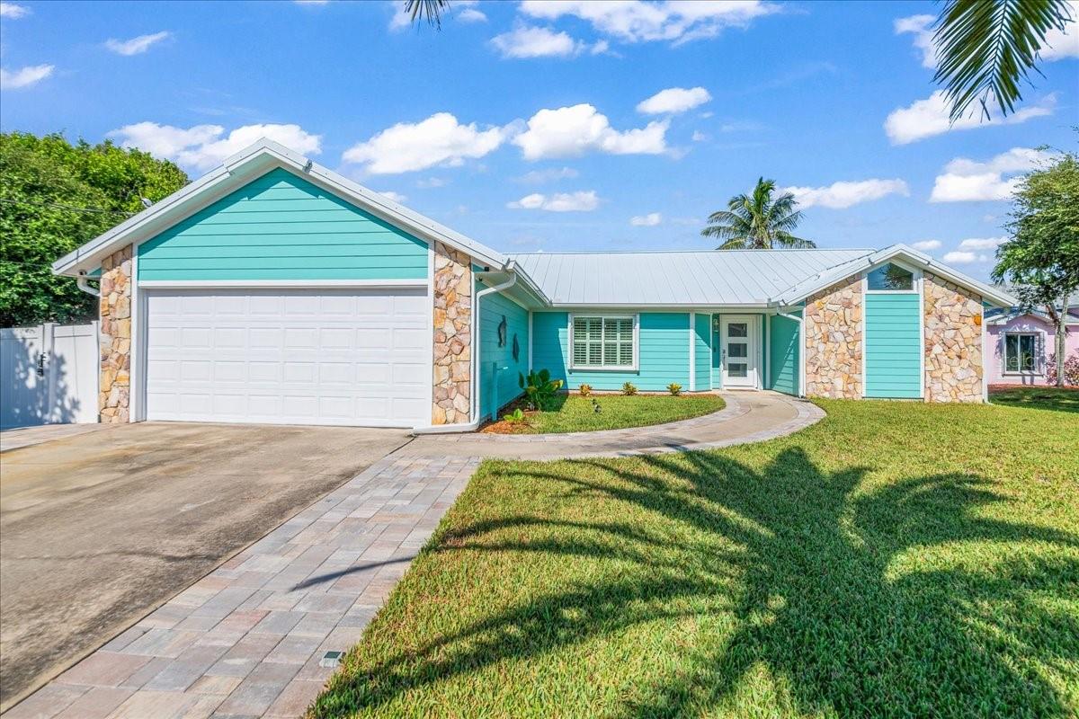Opportunity awaits in the relaxed island lifestyle of Melbourne Beach! Nestled in the desirable Crystal Lakes community, this entirely and beautifully remodeled, upgraded home is filled with natural light thanks to vaulted ceilings, upgraded Pella energy-efficient windows, and a matching sliding glass door. The open-concept kitchen and family room create the perfect space for entertaining, with views of the expansive private backyard. Elegant Designer Fanimation Odyn ceiling fans add both style and comfort throughout the home. A thoughtful split-floor plan offers three bedrooms and two bathrooms, including a spacious owner’s suite complete with a walk-in closet and a walk-in shower. Enjoy the best of coastal living with private beaches, top-rated Brevard schools, and Sebastian Inlet State Park just minutes away. With countless river and ocean access points, along with a variety of dining and entertainment options nearby, this home is the perfect blend of modern upgrades, convenience, and beachside charm. variety of dining and entertainment options nearby, this home perfectly blends comfort, convenience, and the charm of coastal living.