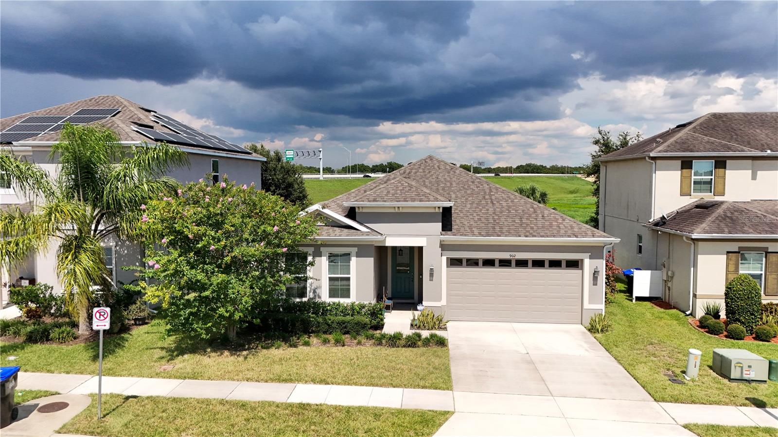 Embrace peaceful surroundings and modern convenience in this 2018-built 3-bedroom, 2-bath home offering nearly 1,800 sq ft of open-concept living space, tucked away in a quiet corner of Hilltop Reserve Phase 3 with a lush evergreen backdrop and no rear neighbors. At the heart of the home, the living, dining, and kitchen areas flow together in one expansive, open space—ideal for family time or entertaining—while quality finishes like solid wood cabinets, stone countertops, and easy-care laminate and tile flooring (with cozy carpet in the bedrooms) add a touch of modern elegance. The attached two-car garage comes equipped with an electric vehicle charging station, reflecting the home’s EV-ready, forward-thinking design. Step outside to your private back porch and garden oasis, which overlook a tranquil green space and are kept lush by an irrigation system—an ideal setting for morning coffee or winding down at dusk. As part of Hilltop Reserve, you’ll enjoy community perks like a clubhouse, pool, playground, and neighborhood sidewalks, and you’re just minutes from the 414 and 429 beltways for an easy commute to Orlando and beyond.