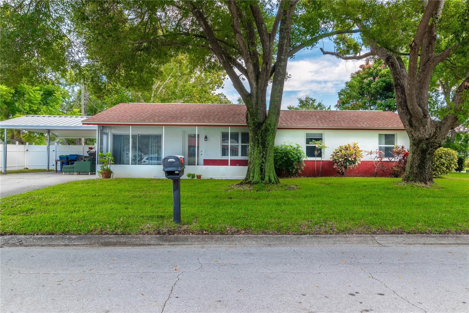 PALM HARBOR HIGH SCHOOL ZONE FOR MIDDLE SCHOOL AND HIGH SCHOOL! NO CDD, NO HOA, NO FLOOD ZONE - LOCATION, LOCATION, LOCATION with a great opportunity to park your boat / RV! NO FLOODING from 2024 hurricanes! This charming home has 3 bedrooms, 2 baths, a bonus room, and it is nestled in the quaint neighborhood of Plantation Grove in the heart of highly desirable Palm Harbor, zoned for Palm Harbor Middle School and Palm Harbor University High School! You will find 2 fully screened-in lanais - one in the front that measures 5x24 sq ft in size and one in the back that is huge as it measures 10x38 sq ft. This corner lot home offers an open floor plan and you will find ceramic tile throughout. Recent upgrades that you will find are NEW up to code electrical wiring throughout, NEW AC and NEW Water Heater (both from 2023), kitchen cabinets have been refaced and new stone countertops. You will also find a laundry room that offers storage and the full size washer and dryer convey with the sale. The spacious bonus / flex room measures 11x19 sq ft and gives you additional heated living space to meet your personal needs - it could be a den, an office, an extra family room and so much more. The backyard is fully fenced in and there are 2 sheds, one of them big enough to be a great work station as it has electricity connected. NEW Vinyl fence to be installed prior to closing! The home also features a carport to park 2 cars or other toys that you will have! You will not find a better location - walking steps to restaurants, bars, shopping and a short distance drive to the beaches, Dunedin, Tarpon Springs and so much more!