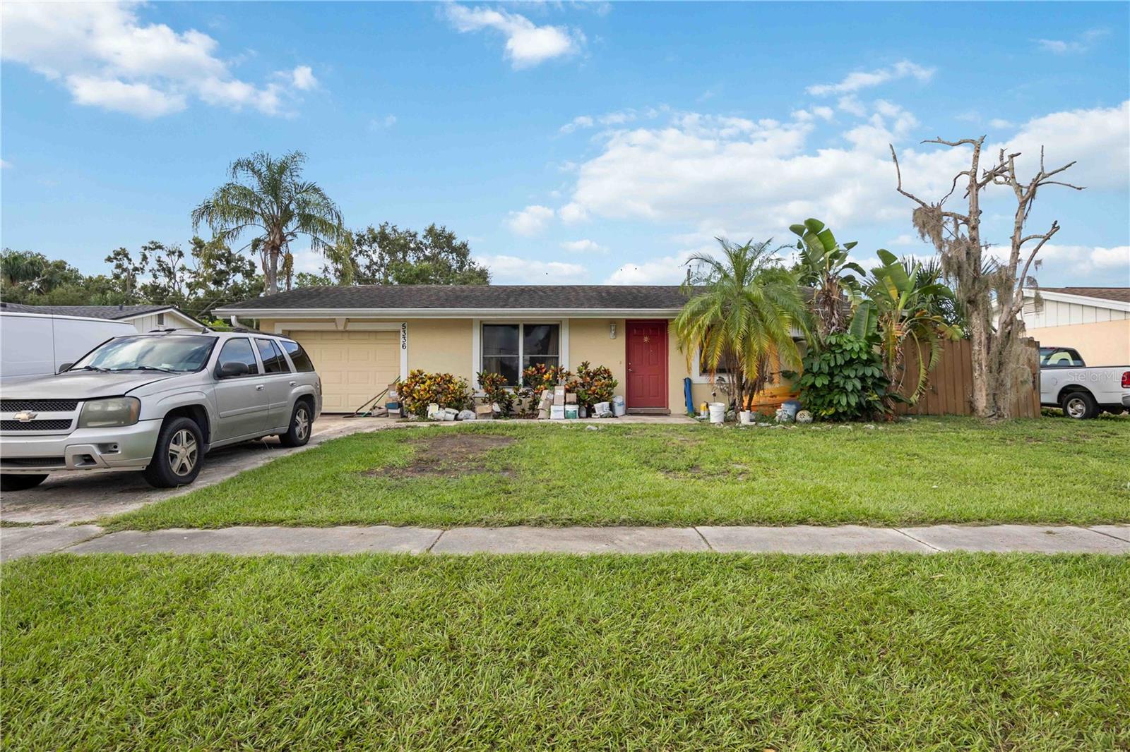 Welcome to this Sarasota home featuring an open floor plan and neutral finishes throughout. The living area flows into the updated kitchen with granite countertops, wood cabinetry, and stainless steel appliances. A spacious dining area with sliding glass doors leads to the screened lanai, perfect for indoor-outdoor living. The primary bedroom offers dual closets and an en-suite bath with a granite double vanity and walk-in shower. Additional bedrooms are well sized and share a full bath with updated finishes. Outside, enjoy a large backyard with mature palms, a screened lanai, and a storage shed. Located close to beaches, shopping, dining, and schools, this home combines comfort and convenience in a desirable Sarasota location.
