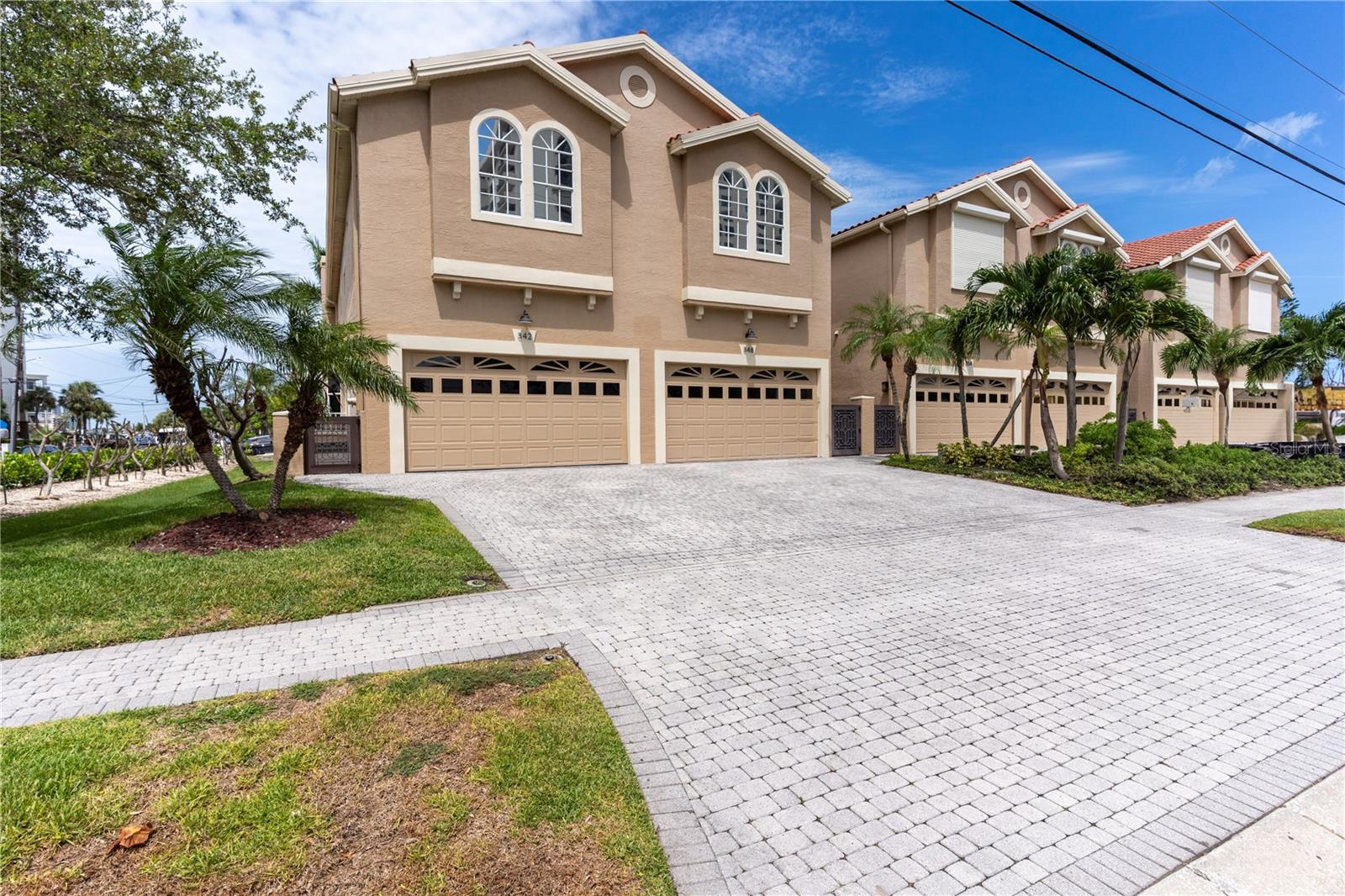 This upscale townhouse on Island Estates is available for long-term lease and offers the perfect blend of luxury, comfort, and resort-style living! One of the townhome's standout features is the private travertine-paved courtyard with a screened plunge pool, ideal for relaxing evenings. The pool is enhanced with LED lighting and wraparound bench seating, creating a serene spot to unwind day or night. Step inside and you're welcomed by a spacious, open layout with soaring ceilings, rich espresso hardwood flooring, elegant crown molding, and architectural columns that add character throughout. The chef-inspired kitchen is equipped with custom cabinetry, stainless steel appliances, granite countertops, and a stylish glass tile backsplash—perfect for both everyday meals and entertaining. The living area includes a wood-burning fireplace and large sliding doors that seamlessly connect the indoor space with the poolside courtyard. Upstairs, the primary suite offers a peaceful escape with two walk-in closets, hardwood floors, a fireplace, and a private balcony that captures water views and beautiful sunsets. The luxurious en-suite bath features a soaking tub, a large walk-in shower, granite vanity, and generous storage. Two additional bedrooms share a modern Jack-and-Jill bathroom, and the laundry area is conveniently located on the same level. An oversized two-car garage provides plenty of room for vehicles, kayaks, or recreational gear. Located less than a mile from Clearwater’s world-famous beaches, steps from grocery shopping, dining, banks, and a post office. A private marina is nearby for added convenience! This is a rare opportunity to lease a well-appointed townhome in one of Clearwater’s most desirable waterfront communities—schedule your private showing today!