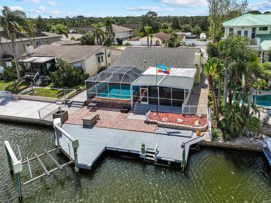 Welcome to your Gulf Coast Boater’s Dream Pool Home in the highly sought-after Sea Pines community—where every day begins and ends on the water.

This exceptional 3-bedroom, 2-bathroom fully updated (2025 with permits) pool home offers 60 feet of concrete seawall, a 10,000 pound boat lift, and an extra-large fixed dock complete with power, water, and a fish cleaning station. Situated on a saltwater canal with direct Gulf access and no fixed bridges, you can be cruising into the open waters of the Gulf of Mexico in minutes. Spend your days watching dolphins and manatees glide by as you fish for redfish, snook, and snapper right from your backyard.

Inside, the home showcases a modern open floor plan designed for coastal living and entertaining with a wood burning fireplace. The fully updated kitchen features granite countertops, a large island, stainless steel appliances, custom pantry, and wood cabinetry, while tile and luxury vinyl flooring flow seamlessly throughout. The spacious master suite offers a large walk-in closet, an upgraded walk-in shower, and private sliding glass doors leading directly to the pool—perfect for late-night swims under the stars. Additional highlights include an updated guest bathroom, a bright sunroom overlooking the canal, and an additional screened room for relaxing in the coastal breeze. 

Step outside to your private oasis featuring a screen-enclosed gunnite pool and separate hot tub, creating the ultimate setting to unwind after a day on the water.

Roof was installed in 2019. New Air Conditioner in 2023. Assumable Flood insurance is $3770 a year. Current homeowners insurance is $2700 a year. New pool equipment in 2025. New hot water heater in 2026. Oversized one garage for all your fishing and boating supplies. Walk around attic storage with easy stair access. 

Located in the heart of Sea Pines, this home benefits from the community’s exclusive Coast Guard–marked channel, a rare feature in Hudson that ensures reliable, well-maintained Gulf access. Whether you’re heading out for a sunset cruise, a day of offshore fishing, or scalloping season, you’ll appreciate how quickly and easily you can reach open water.

Boating adventures abound in every direction. Cruise about 40 minutes south to the famous Anclote Key Sandbar, where shallow sandy flats and clear water create the perfect gathering spot. Just beyond lies Anclote Key Preserve State Park, an unspoiled barrier island ideal for exploring. Head north and you’ll find the popular Hernando Beach Flats, along with easy access to the Weeki Wachee River, Homosassa River, and Crystal River—all known for waterfront dining, vibrant boating communities, and refreshing 72-degree spring waters.

Sea Pines residents also enjoy access to a private boat ramp for just $115 per year, making launching your next adventure effortless. With an optional civic association (no strict HOA), you’ll experience the perfect balance of freedom and community.

Just minutes away, Hudson offers a laid-back coastal lifestyle with marinas, waterfront restaurants, and tiki bars, plus convenient access to shopping, dining, and medical facilities along US-19. Tampa International Airport is roughly an hour away, and Orlando’s world-famous attractions are within easy reach.

This is more than a home—it’s a lifestyle.

Live where the tides set the pace, the Gulf is your backyard, and every day feels like a vacation.