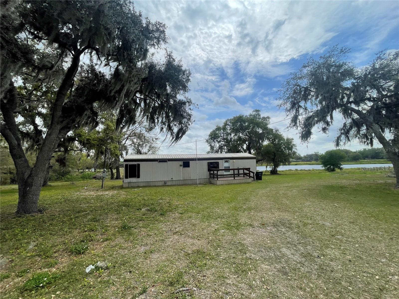 FL living at an affordable price or great investment property! This 2BD/1BA home is situated on 2.25 acres. Short distance to all shopping, schools, medical facilities, and restaurants. Make this your new winter retreat or year around home. Call today, don't miss this great investment opportunity.