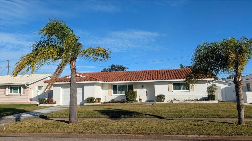 Nestled in serene deed-restricted Williamsdale Square neighborhood "NO FLOOD zone," yet minutes to Tom Stuart Causeway and Madeira Beach! The open floor plan of this charming block home invites for coastal living in a bright atmosphere, complemented by new high-impact PGT windows with LIFETIME WARRANTY! Enjoy the convenience of an inside laundry room off the kitchen. From your panoramic family room, step outside to spacious patio, perfect for relaxing or entertaining with family and friends. The backyard is vinyl fenced, offering privacy and a safe space for outdoor activities and gardening. Natural gas in the community keeps your energy bills down. Key updates include: new A/C in 2023, Kohler toilets, a charming red barrel tile roof in 2014, fire-proof door between garage and inside area, new high-impact garage door, all replaced valves & water hoses. Annual termite bond (tented in 2024) with "Magnum Termite." Located in X-flood zone - approximately 35 ft above sea level - no evacuation zone - this home did not experience any flooding or damage from recent storm. Minutes to Madeira Beach Fundamental School (K-8), Gulf beaches, Bay Pines VA, Tyrone Mall and new Seminole City center with movie theater, restaurants, bars, St. Pete College, Seminole Rec Center, Library & Post Office. MOVE-IN READY, loved, and well cared-for by the same owner for over 30 years, this beauty with lovely curb appeal is now ready for a new owner and upgraded cosmetic touches  - hurry - it won't last at this affordable price!