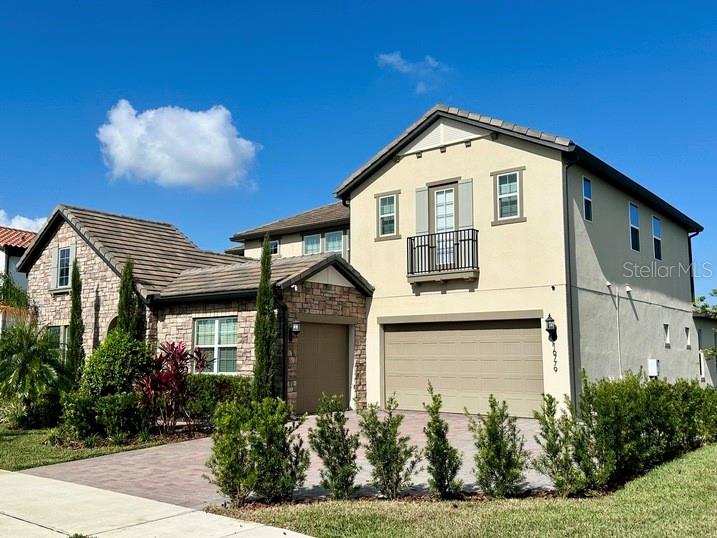 This wonderful Lakefront property is situated in the gated section of Waterside. From the street the property looks like a 2 story home but has the benefit of a huge split level basement with secondary master suite leading through the electric screened lanai to the fenced salt water pool and heated spa. Entering the property down a covered walkway with private open courtyard you are immediately met by a bright and airy open plan living area with spectacular views of the lake from every window and further views of the pool and dock from the two large balconies on 1st and second floors, the basement level and 1st floor have electric screens. The first floor has the primary bedroom and large bathroom with oversized shower and free standing bath tub, two huge walk in closets and dual sinks, the first floor also has a second bedroom with en suite bathroom, additional rooms on the 1st floor include an office, dining room and laundry room. Upstairs there is a large loft, four further bedrooms with two bathrooms and a second laundry room with front load washer and dryer Downstairs, in addition to the secondary primary suite or in law suite there is a large bathroom and large walk in closet as well as lots of storage closets. The whole of the lower floor is laminate flooring. The home sits on one of the widest lakefront lots in the community with in excess of 125ft of lake frontage, the driveway has been extended to accommodate at least 4 cars. The community pool and gym is a short walk from the house. Waterside is located close by to the 429, turnpike, Winter Garden Village and Hamlin for excellent shopping