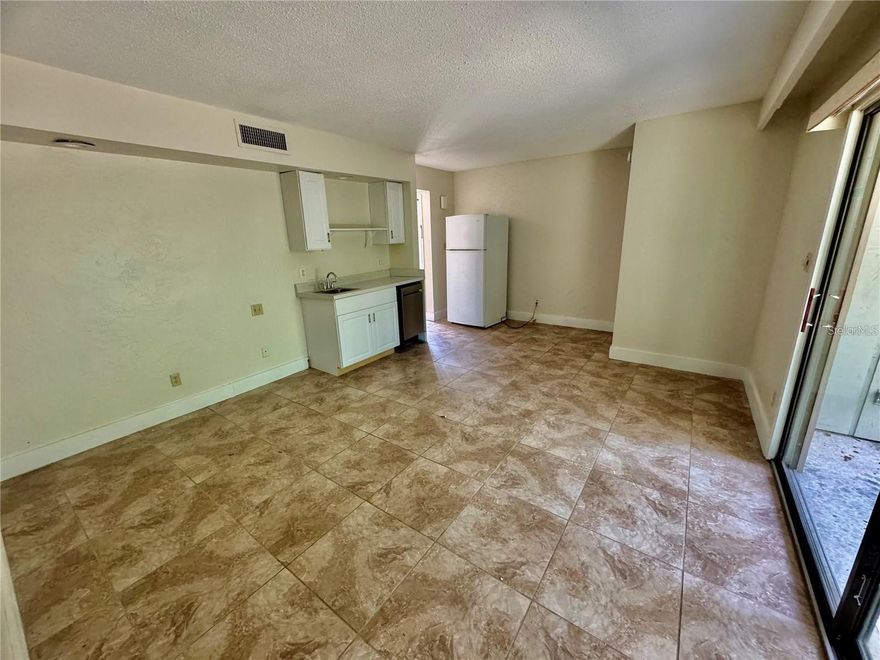 Unfurnished studio condo available for rent! Located on the first floor with golf views. Kitchenette features a dishwasher, fridge and cabinet space. Full sized bathoom with double sinks and spacious quarters for your bedroom and living space. Tile throughout.  Available Dec 1 2025