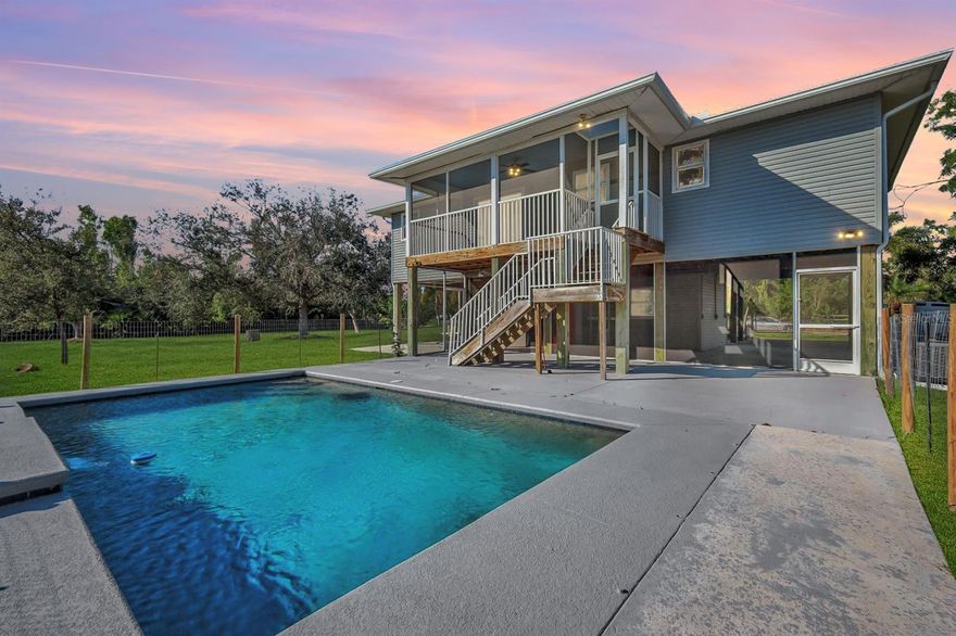 UPDATED SOUTHERN EXPOSURE POOL HOME ON 1 ACRE! Nestled in a serene island setting with desirable southern exposure, this 2 story island home features 2 bedrooms, 2.5 bathrooms and is just minutes from marinas, parks, premier fishing and boating destinations. The recently updated open-concept layout is enhanced by fresh paint, wood plank LVT flooring and vaulted ceilings, creating an airy and inviting atmosphere. A perfectly appointed kitchen serves as the heart of the home, boasting an island with ample storage, sleek quartz countertops, a stylish tiled backsplash, stainless steel appliances and premium finishes—ideal for both everyday living and entertaining. Featuring two spacious bedrooms, each with its own en-suite bathroom, the primary bath is elegantly tiled from floor to ceiling for a spa-like experience. Additionally, a separate powder room with classic wainscoting adds charm and convenience for guests. Sit on the screened in lanai sipping your favorite cocktail and enjoy overlooking the vast landscape with wide open views. Situated on just under an acre, the fully fenced property provides plenty of space for a lush garden, extra storage, or room for all your outdoor toys. A sparkling blue pool with a cascading waterfall feature creates a private backyard oasis, perfect for relaxation. For those who enjoy hands-on projects, a lower-level unfinished workshop with additional storage and workspace for hobbies. Surrounded by mature trees and the natural beauty of the island, this home is a true retreat, while its prime location near Pineland Marina ensures easy access to the water and all the adventures that come with island living. Food Zone X for further savings! Come see what world class fishing, boating and island life is all about. Call your agent to schedule a private tour!