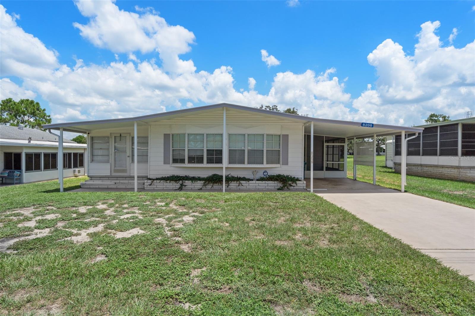 Beautifully maintained 2 bedroom, 2 bath home located on the #1 green of the golf course! Featuring new laminate flooring, a metal roof-over, and a glass-enclosed Florida room offering peaceful golf course views. Handicap accessible with a convenient wheelchair lift. Additional highlights include a private well for irrigation, monthly pest control service, and a new HVAC system installed in 2021. This home combines comfort, convenience, and location in one perfect package! Located in the vibrant High Point Golf Community, this home offers resort-style living in a friendly, active 55+ neighborhood. The High Point Community offers tons of amenities such as Golf, tennis, pickleball, heated pool, social events and so much more. High Point is located close to shopping, restaurants, entertainment, and medical facilities. Low HOA fees and you OWN YOUR OWN LAND.