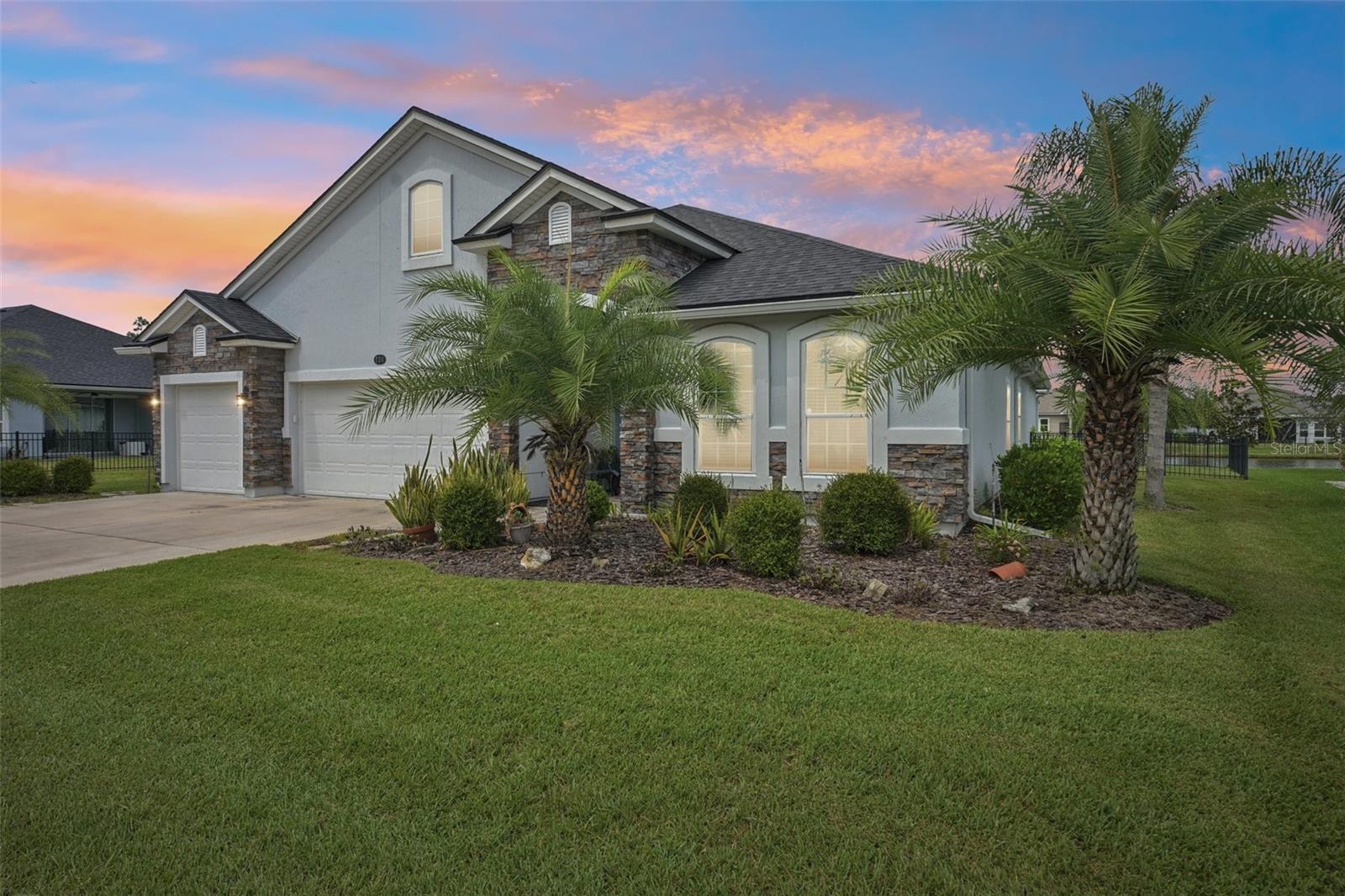 Gorgeous well maintained 3 car garage 4 bedroom 3 full bath home on pond now available! Located in the low HOA neighborhood of Deerfield Meadows in sunny St Augustine FL! Come check out this open floor plan home with beautiful curb appeal, stone accents out front, fully fenced backyard, wide open lot, large Foyer entry with 2 bedrooms and guest bathroom at front of home perfect for guests visiting. As you enter the home you are invited into the large and spacious open floor plan with lots of space for entertaining offering a formal combo living and dining space, all stylish tile flooring throughout the home, gourmet kitchen with built-in wall oven and new upgraded smart technology wifi GE Profile cooktop, tons of space for prepping meals at the California style island offering additional seating with additional space for the everyday table setup! Large open windows and sliding glass doors that hideaway at the screened-in paved back patio! Offers privacy, recessed decorative ceiling with water views of the pond, his and hers closets and separate vanities, walk in shower and separate soaking tub. The final and 4th bedroom is located on the opposite side towards the back of the home with its own bathroom offering total privacy and a walk-in shower. Home comes with a whole house generator, whole house water filtration system connected to the water heater. Electric Awning out back over the exterior paver patio for additional shading! This home is a must see. Fabulous location with low HOA. Minutes to the heart of St. Augustine, Beaches, Medical, Restaurants and a 15 minute drive to Historic St. Augustine area!