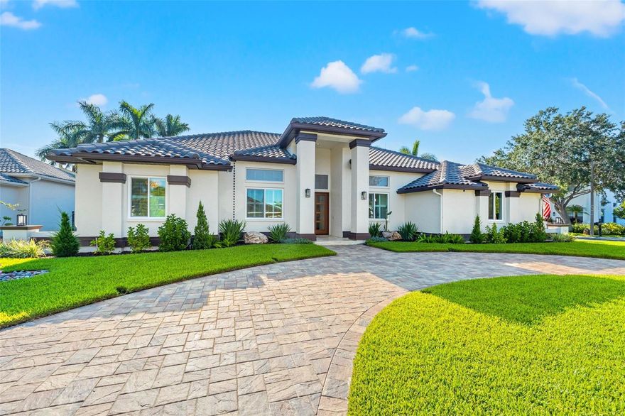 Welcome to luxury living in the prestigious gated community of Placido Bayou. This custom estate home displays high-end finishes & thoughtful design, nestled within a private, deed-restricted, 24/7 guard-gated haven. A nature lover's paradise, this community offers tree-lined walking paths & picturesque ponds. Situated on a sprawling corner lot w/circular paver drive, this residence boasts a stunning remodel. Your journey begins as you approach the travertine-tiled entryway & striking NEW front doors that serve as a fitting introduction to the thoughtfully designed living space, all conveniently on one level. Designed w/ entertainment in mind, this home features soaring ceilings, crown molding, freshly painted, tile floors, custom draperies & stacked stone fireplace. Indulge in culinary luxury w/ an array of top-tier appliances. This kitchen was completely renovated and in the heart of it, is the Elise 48” induction cooktop w/convection oven. Plus, a NEW Wolf microwave. The built-in GE Monogram refrigerator seamlessly integrates into the cabinetry. Cleaning up is a breeze w/ the Bosch dishwasher, a reliable companion. Display lighting illuminates the upper cabinets, along w/under-cabinet lighting offering added ambiance. The cabinetry is adorned w/ brass hardware & beveled edge quartz countertops, combining beauty w/ durability. Adjacent to the kitchen, is the indoor laundry w/ Electrolux washer & gas dryer. The main suite is a spacious retreat that overlooks the pool and offers custom closets & new draperies that enhance the space. The ensuite bathroom is a masterpiece of marble tile, complete w/an elegant chandelier that highlights the soaking tub. The newly installed pool bath steam shower is perfect for unwinding after a long day & is surrounded by stunning glass tiles that capture the light. All bathrooms have undergone renovations, showcasing the owner's commitment to exceptional living. Kohler vanity mirrors w/built-in Bluetooth & custom wallpaper, creating an atmosphere that is uniquely inviting and chic. A designer's touch is evident in the powder room, where wallpaper adds a layer of texture. Plantation shutters, newly installed adorn the bathrooms, adding privacy while enhancing their aesthetic appeal. Step outside to the backyard oasis designed for ultimate relaxation and entertainment. NEW gas-heated pool/spa w/ stunning travertine deck. Your outdoor experience is further enriched by a NEW detached 15 x 15 air-conditioned workout rm (also suitable as an office), NEW outdoor kitchen w/Napoleon Gas Grill & Blaze refrigeration, an outdoor area under porch canopy accented by a hardy board ceiling, professional landscaping w/ boulders, a vinyl fence, & an outdoor lighting system. You will enjoy the CLUB ROOM that seamlessly opens to the pool & is sure to be your ultimate gathering spot. This home is equipped w/modern conveniences, including a NEW Vivint security system, NEW Trane A/C w/ Dehumidifier, NEW Sonos Sound System, NEW Garage Flr epoxy, NEW Electric Car Charging Station, Tankless water heater, NEW PGT hurricane-rated windows, sliders & garage dr, Murphy Bed, NEW water softener, NEW fans, & NEW Seamless Gutters. Discover the joy of living in St. Pete, one of the top-rated places to reside in America. W/ easy access to Tpa International Airport, dining, cultural attractions, sports venues, Vinoy Golf Club & white sandy beaches, this is more than a home—it's a lifestyle.