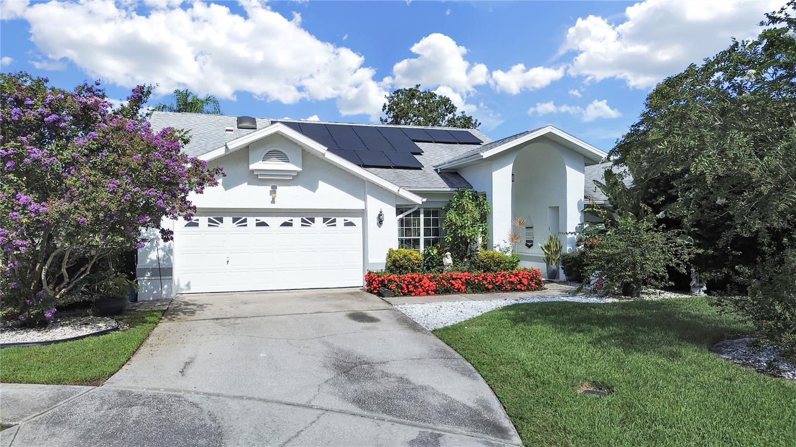 Welcome to this beautifully maintained 3-bedroom, 2-bath, 2-car garage home nestled on a quiet cul-de-sac in the highly desirable Southern Oaks community. Ideally located near top-rated schools, shopping, and dining, this home combines comfort, convenience, and style. Step through the elegant double-door entry into a light-filled interior featuring soaring vaulted ceilings and transom windows that flood the space with natural light. The open, split floor plan offers both privacy and flow, with sleek, modern tile flooring throughout the main living areas. The spacious kitchen is a chef’s dream with an abundance of cabinetry, generous countertop space, and stainless steel appliances. It opens seamlessly to the great room and cozy breakfast nook, creating the perfect setting for everyday living and entertaining. A charming wood-burning fireplace adds warmth and character to the living space. The formal dining room offers flexibility to be used as a home office, den, or playroom. Retreat to the luxurious primary suite with double-door entry, vaulted ceilings, and sliding glass doors that open directly to the pool area. The en-suite bath features dual sinks, a large linen closet, and a separate vanity area. The heart of this home is the expansive, screened-in lanai with skylights—an ideal outdoor living space for relaxing or entertaining year-round. Step outside to enjoy the sparkling pool surrounded by serene views of the pond and lush conservation area—no rear neighbors! Additional highlights include energy-saving solar panels , which significantly reduce electric costs. Don’t miss this rare opportunity to own a move-in ready home with peaceful nature views, and resort-style outdoor living—all in a prime location!