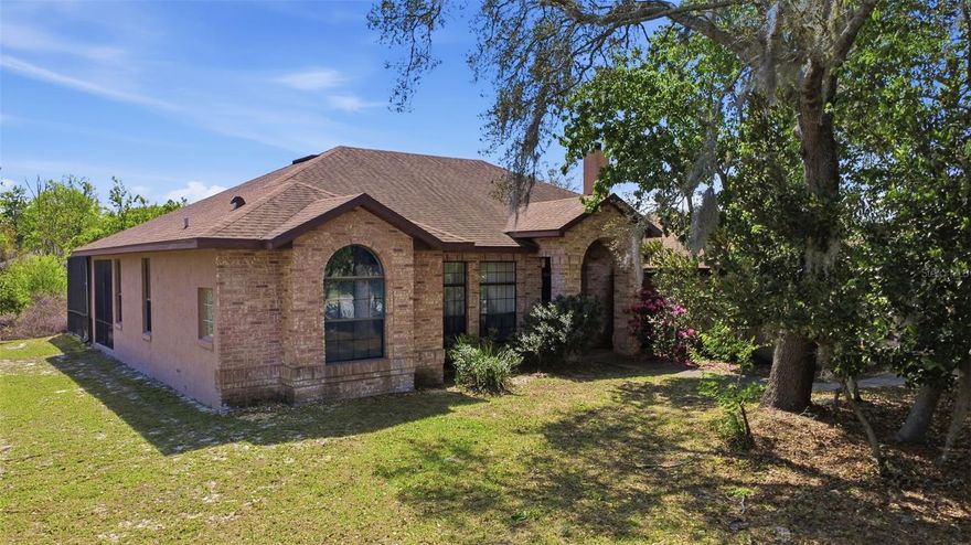 This is your RARE chance to own your own private retreat in the highly sought after Orlandia Heights community! Situated on a 1-acre corner lot in the heart of DeBary, this move in ready property offers the perfect blend of space, privacy, and convenience while just minutes from shopping, a short drive to Highbanks Marina, and close to Rob Sullivan Park.

This 4-bedroom, 2-bath home features a desirable split floorplan, offering both functionality and flexibility. The 4th bedroom has its own private entrance, making it ideal for an in-law suite, adult child, game room, or private office.

You’ll love the 3-car garage connected by a screened breezeway, with space for multiple vehicles and even deep enough to accommodate a boat—perfect for those who want to enjoy nearby river access.

Step outside through French doors to your screened-in patio and sports pool (shallow ends with a deeper center), surrounded by natural woods for a truly peaceful and private setting. Whether it’s morning coffee or weekend gatherings, this backyard was made for enjoying Florida living.

The kitchen sits in the heart of the home, featuring solid wood cabinets, granite countertops and backsplash, and stainless steel appliances, keeping you connected to every moment.

With NO HOA and rural residential zoning, you’ll have the freedom to bring your toys, explore homesteading, and even have animals. There’s still plenty of room to expand, customize, or simply enjoy the space and privacy.

Opportunities like this don’t come up often so don’t miss your chance to own a full acre in one of DeBary’s most peaceful and desirable neighborhoods. Schedule your showing today before it’s gone! This home may be under audio and/or visual surveillance.